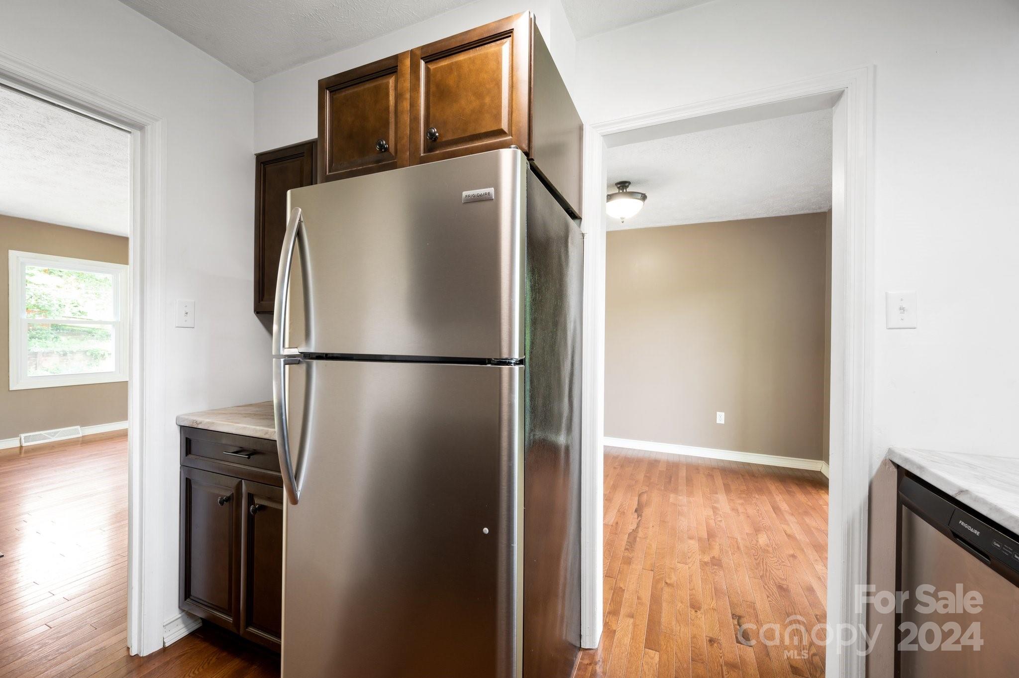 12 South Ridge Place Arden, NC 28704 - Photo 12 of 41 a view of a refrigerator in kitchen and an empty room