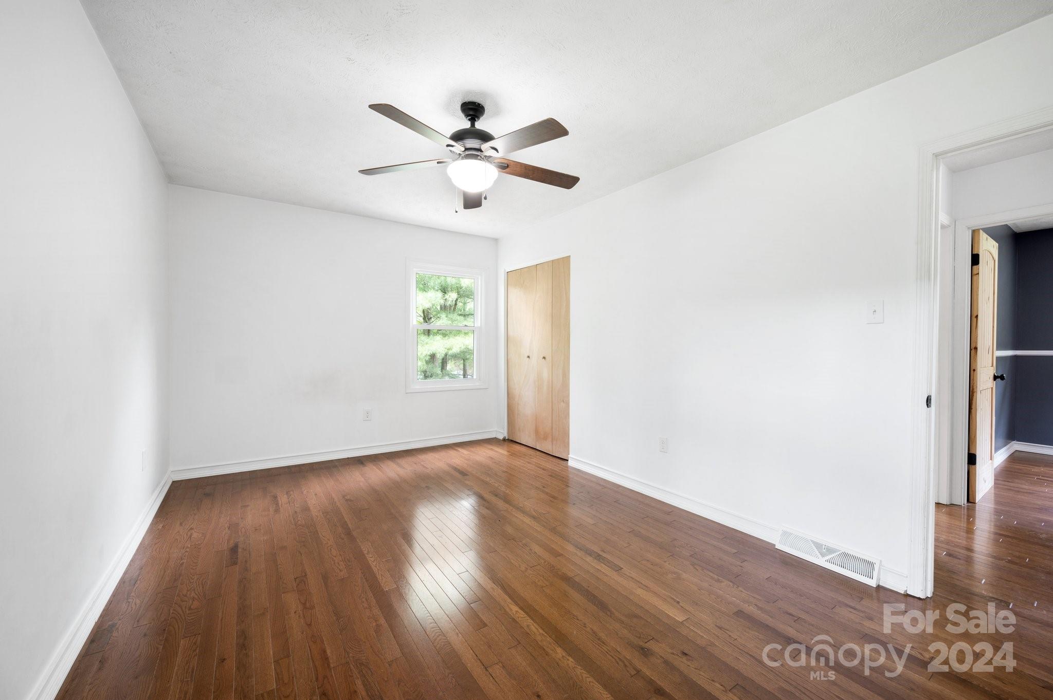 12 South Ridge Place Arden, NC 28704 - Photo 16 of 41 an empty room with wooden floor fan and windows