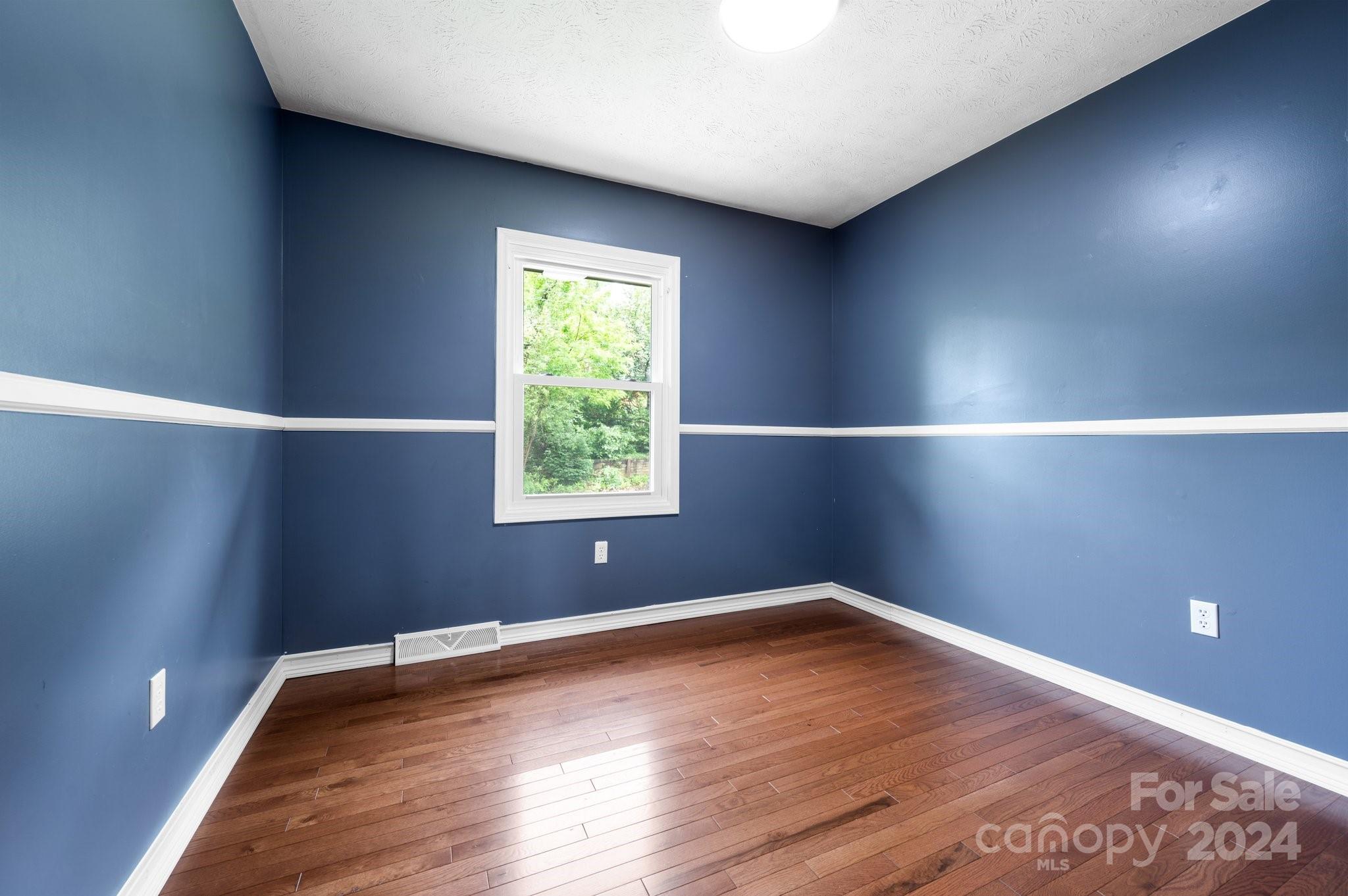 12 South Ridge Place Arden, NC 28704 - Photo 19 of 41 a view of an empty room with wooden floor and a window