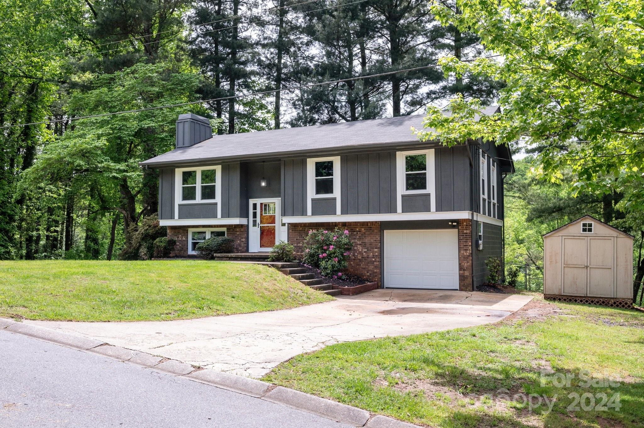12 South Ridge Place Arden, NC 28704 - Photo 2 of 41 a view of a house with a yard plants and large tree