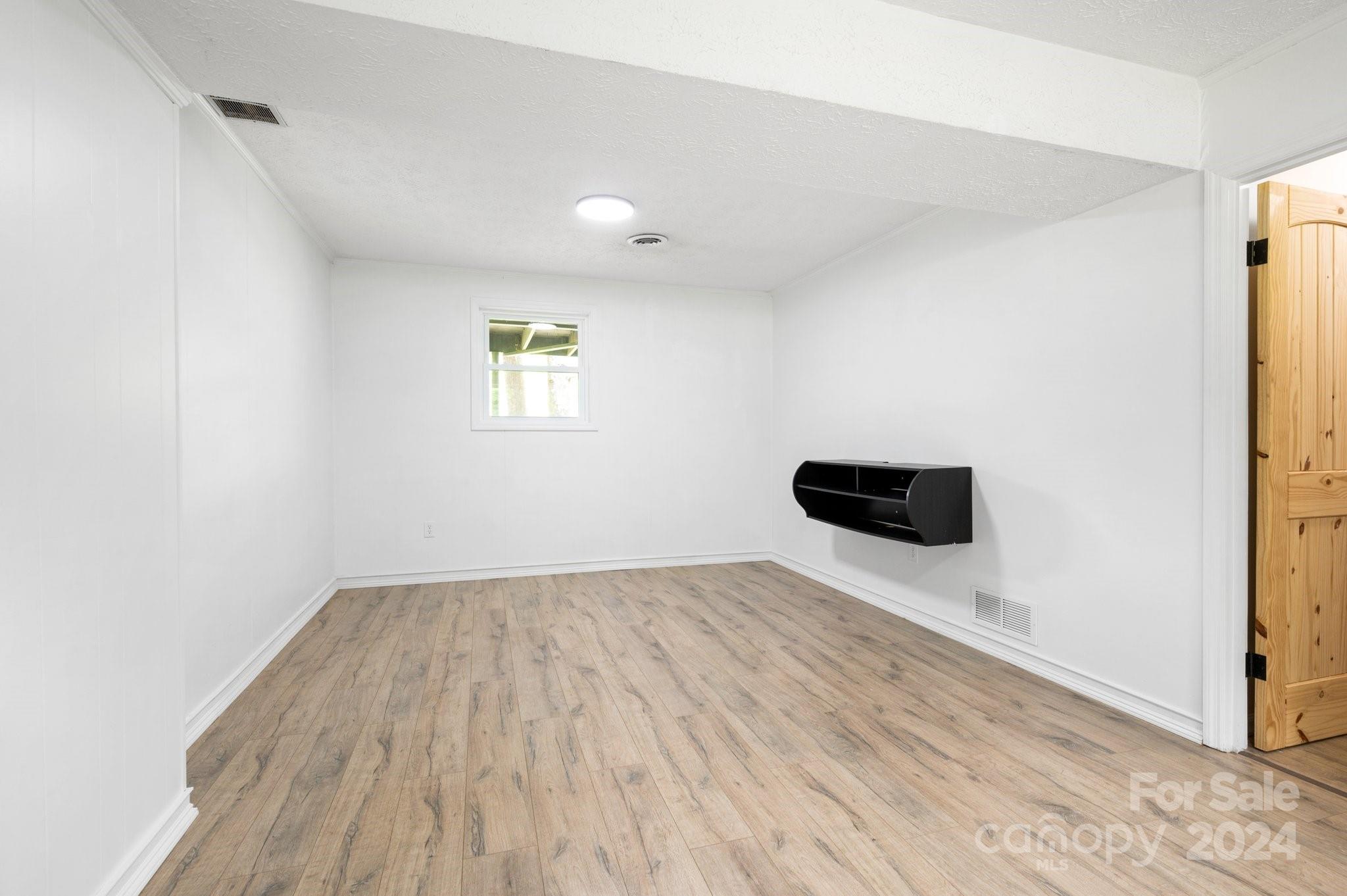 12 South Ridge Place Arden, NC 28704 - Photo 23 of 41 an empty room with wooden floor and windows