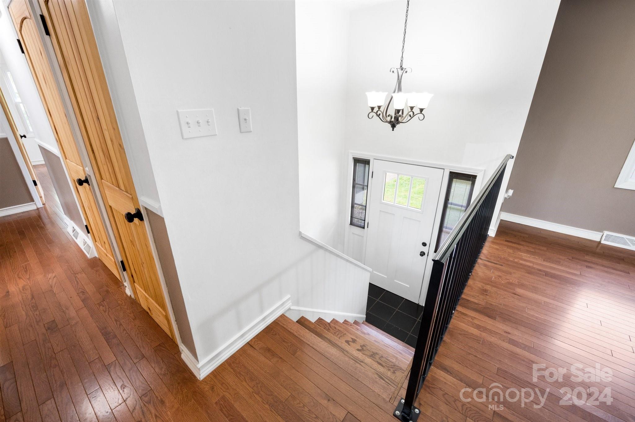 12 South Ridge Place Arden, NC 28704 - Photo 3 of 41 a view of a hallway with wooden floor and staircase