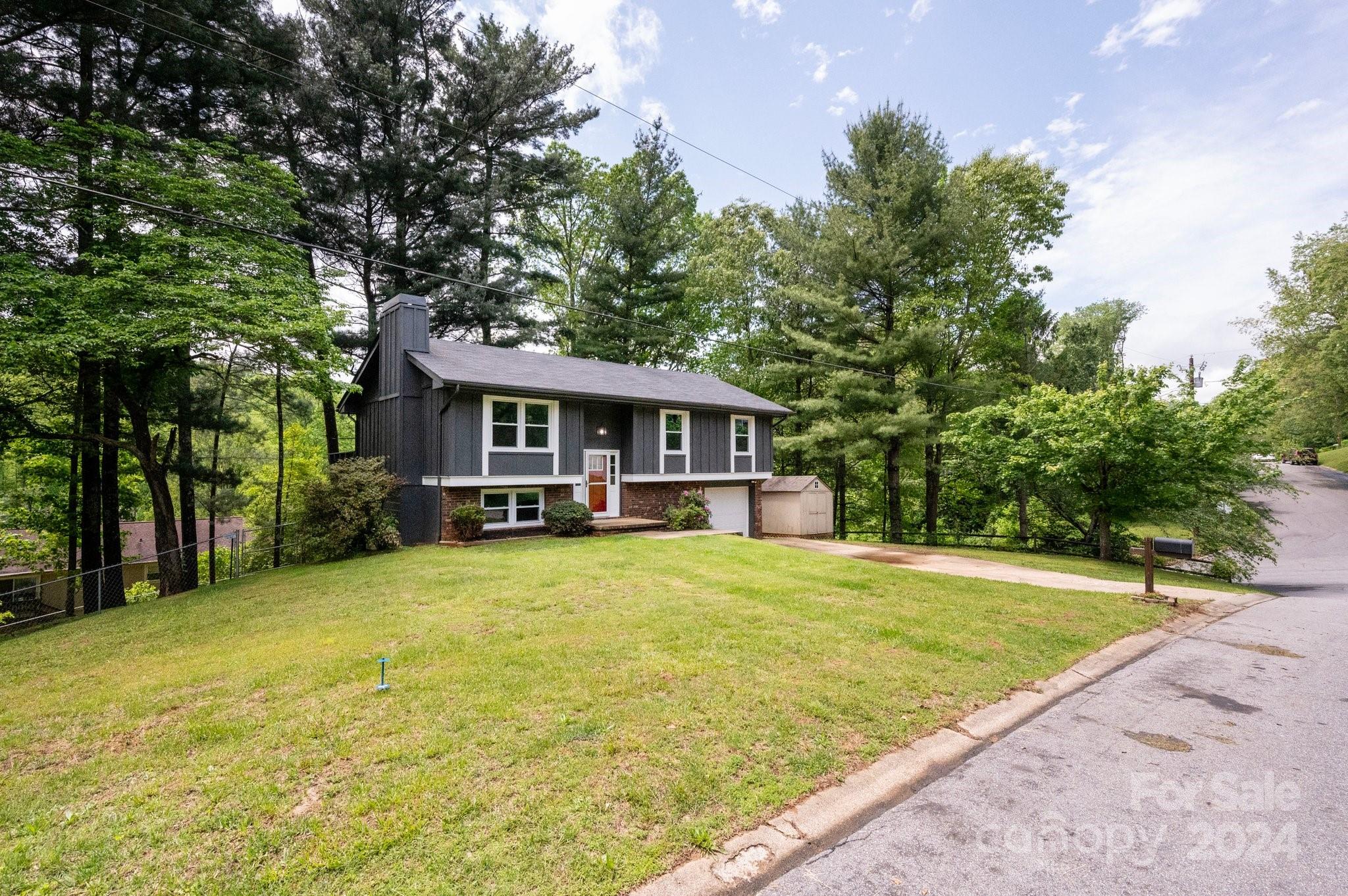 12 South Ridge Place Arden, NC 28704 - Photo 32 of 41 a front view of a house with yard patio and green space
