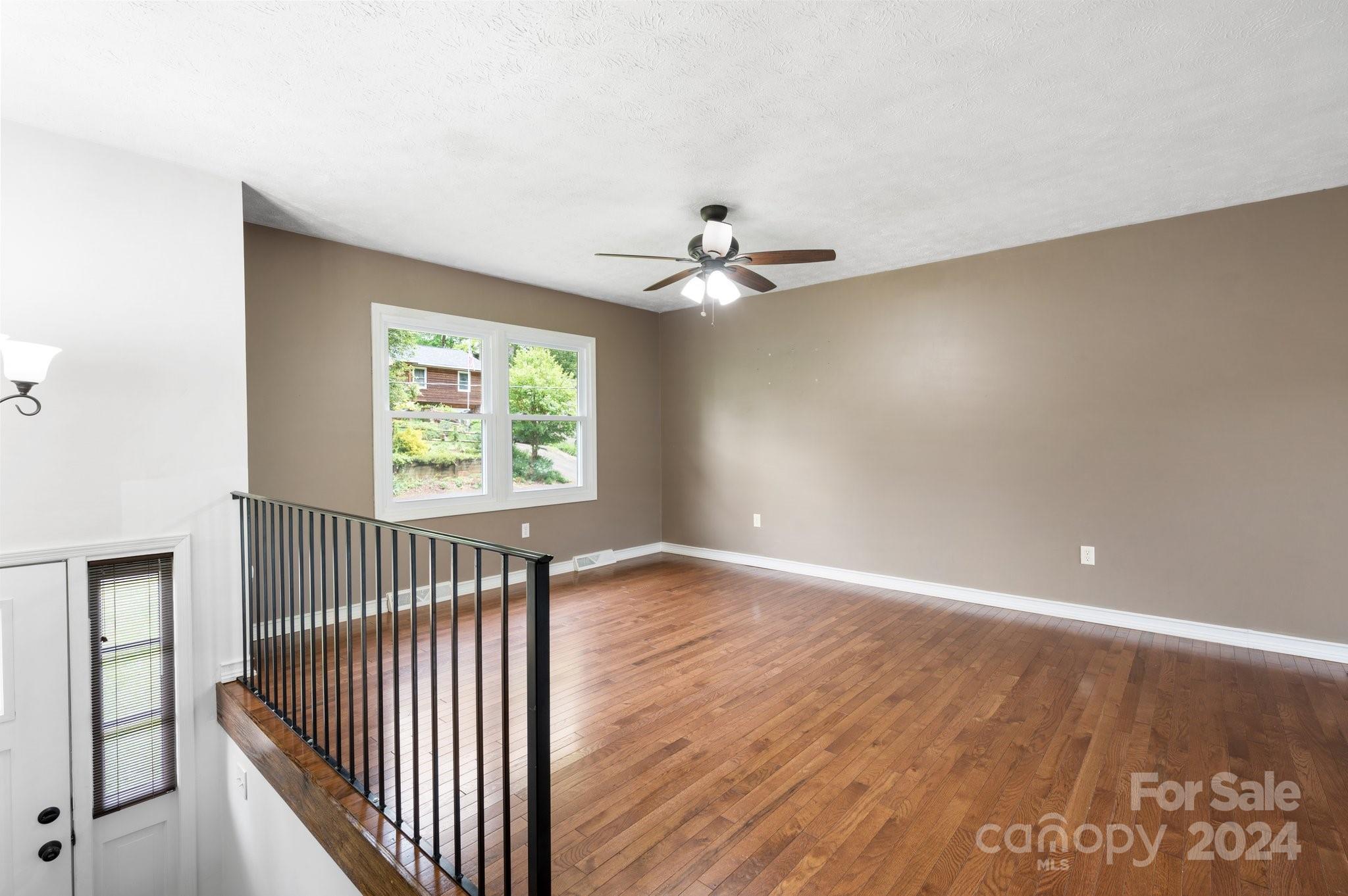 12 South Ridge Place Arden, NC 28704 - Photo 4 of 41 wooden floor in an empty room with a window