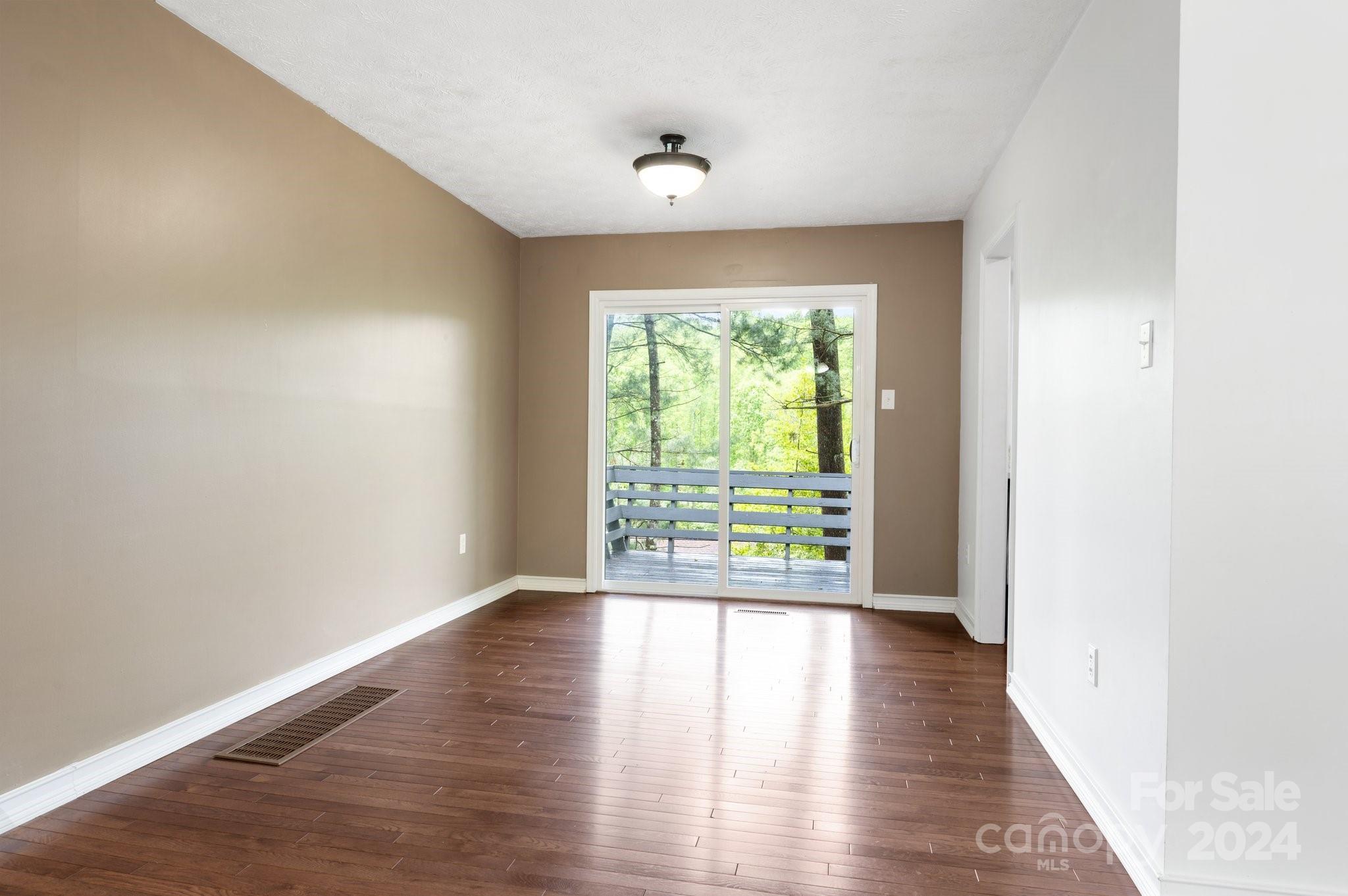 12 South Ridge Place Arden, NC 28704 - Photo 8 of 41 a view of an empty room with wooden floor and a window