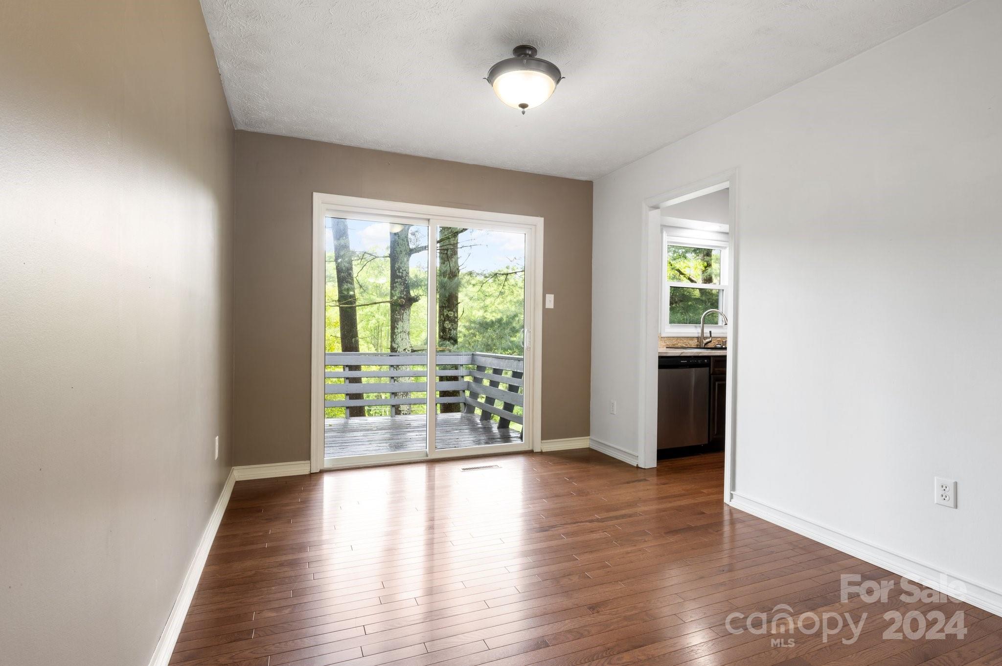 12 South Ridge Place Arden, NC 28704 - Photo 9 of 41 an empty room with wooden floor and windows