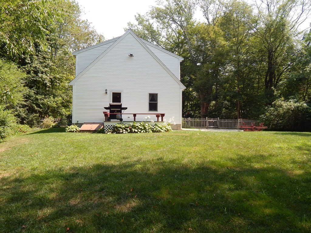 25 Forge Road Freetown, MA 02702 - Photo 18 of 21 a view of backyard of house with wooden deck and seating space