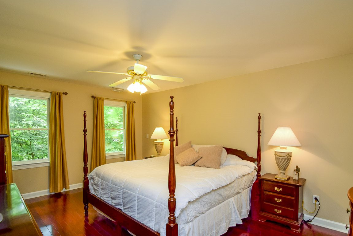 4600 Salem Ridge Road Holly Springs, NC 27540 - Photo 13 of 25 Spacious master bedroom with loads of natural light and peaceful wooded views. Master Bedroom