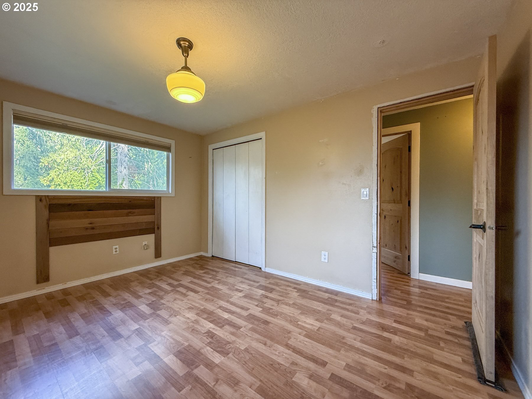 26609 South Elwood Road Colton, OR 97017 - Photo 12 of 38 a view of an empty room with window and wooden floor