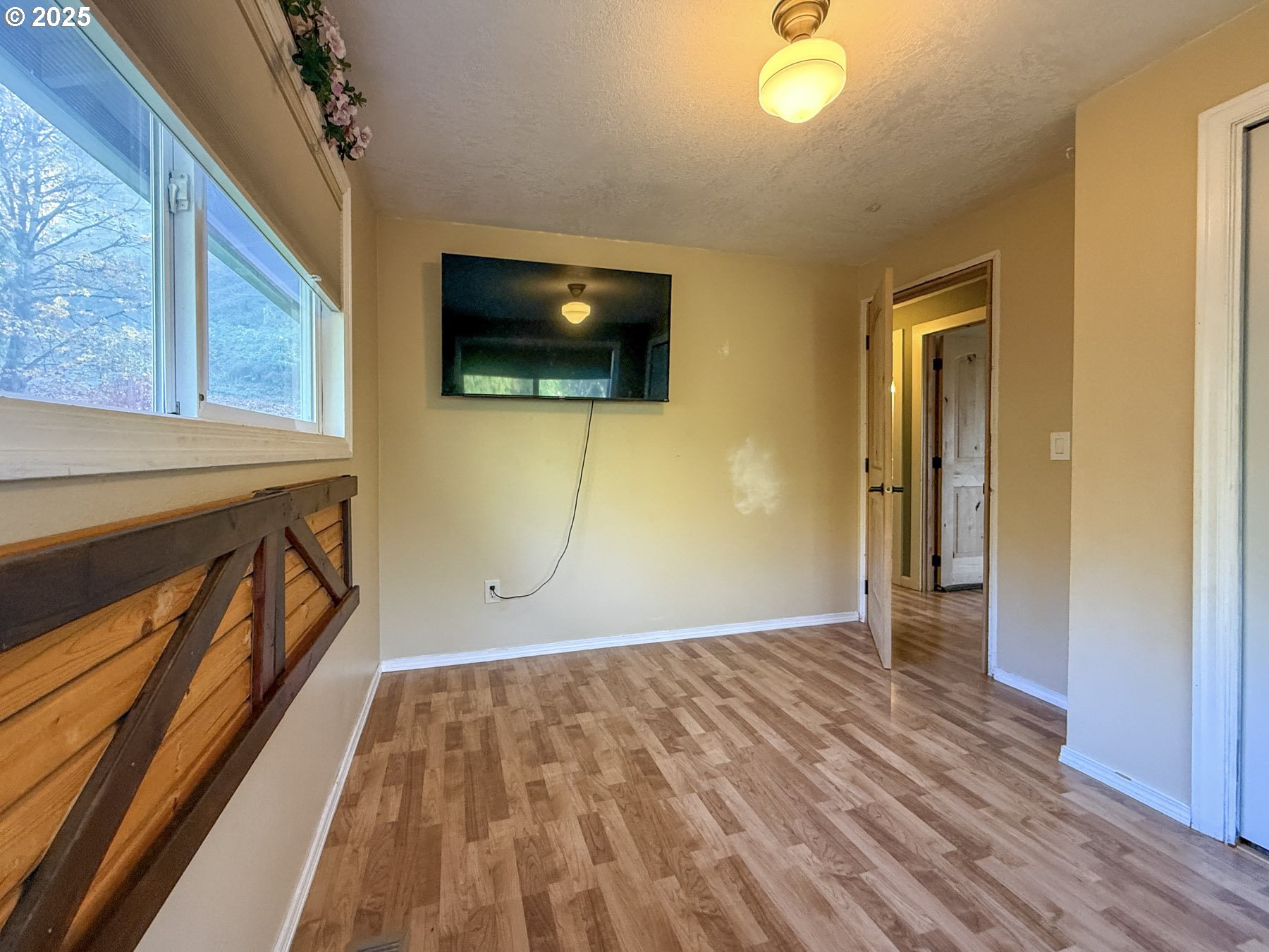 26609 South Elwood Road Colton, OR 97017 - Photo 13 of 38 a view of empty room with wooden floor and fan