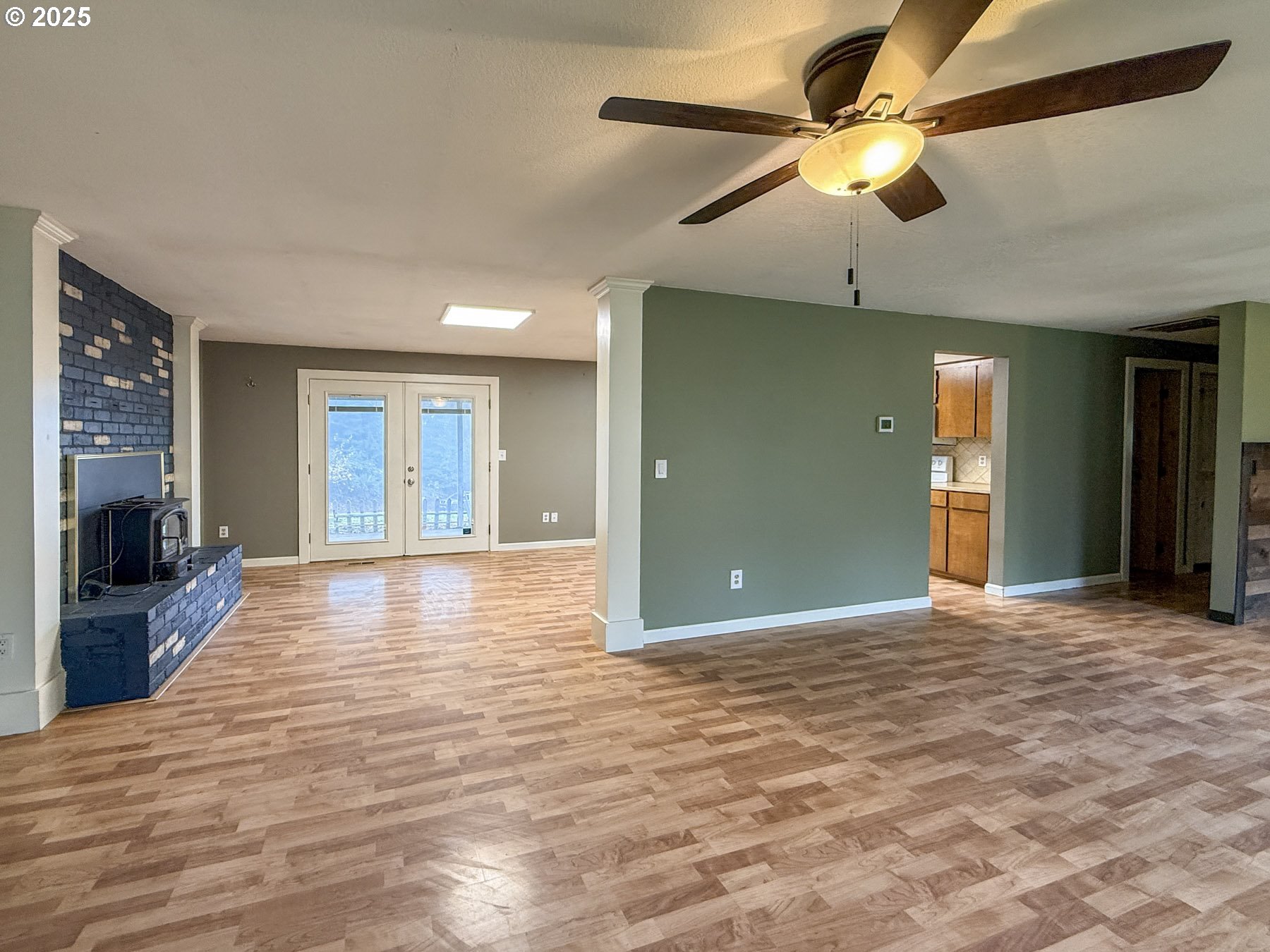 26609 South Elwood Road Colton, OR 97017 - Photo 4 of 38 a view of an empty room with wooden floor and a ceiling fan