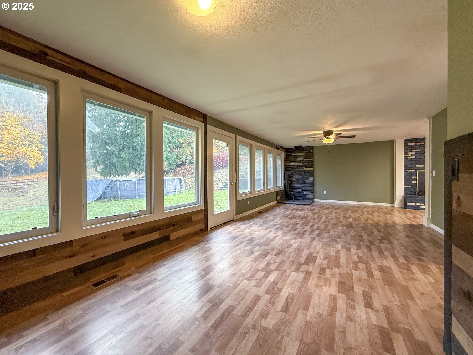 26609 South Elwood Road Colton, OR 97017 - Photo 5 of 38 a view of an empty room with a window and wooden floor