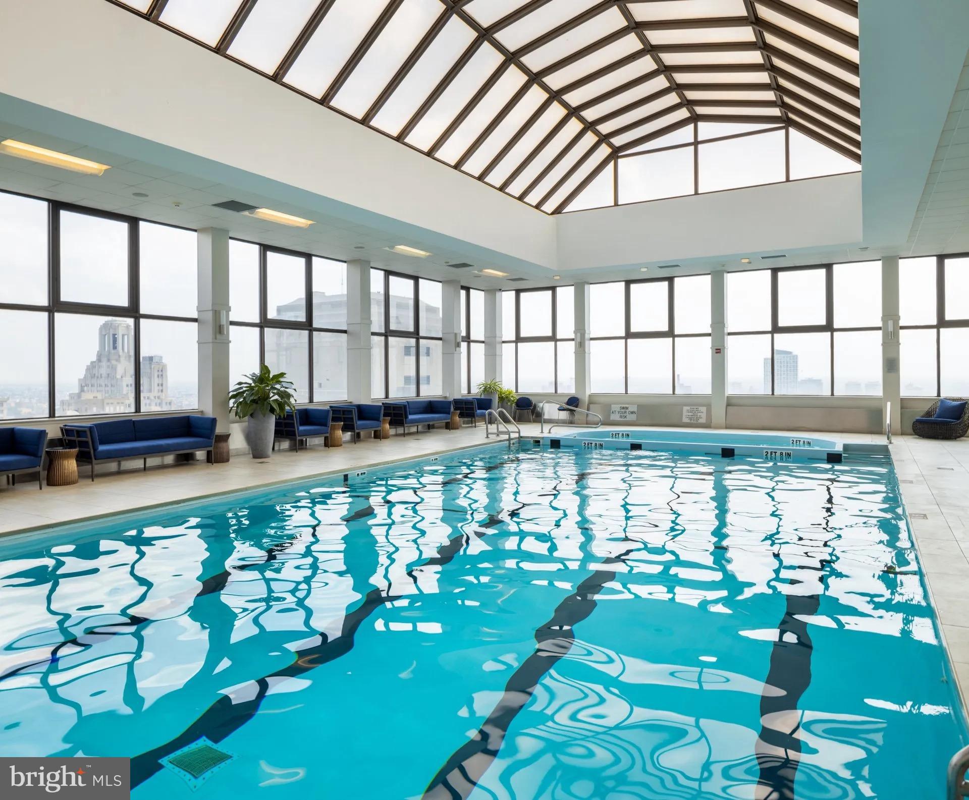 1500 Locust Street, Unit 2B2413 Philadelphia, PA 19102 - Photo 1 of 25 a view of a large swimming pool with an outdoor seating