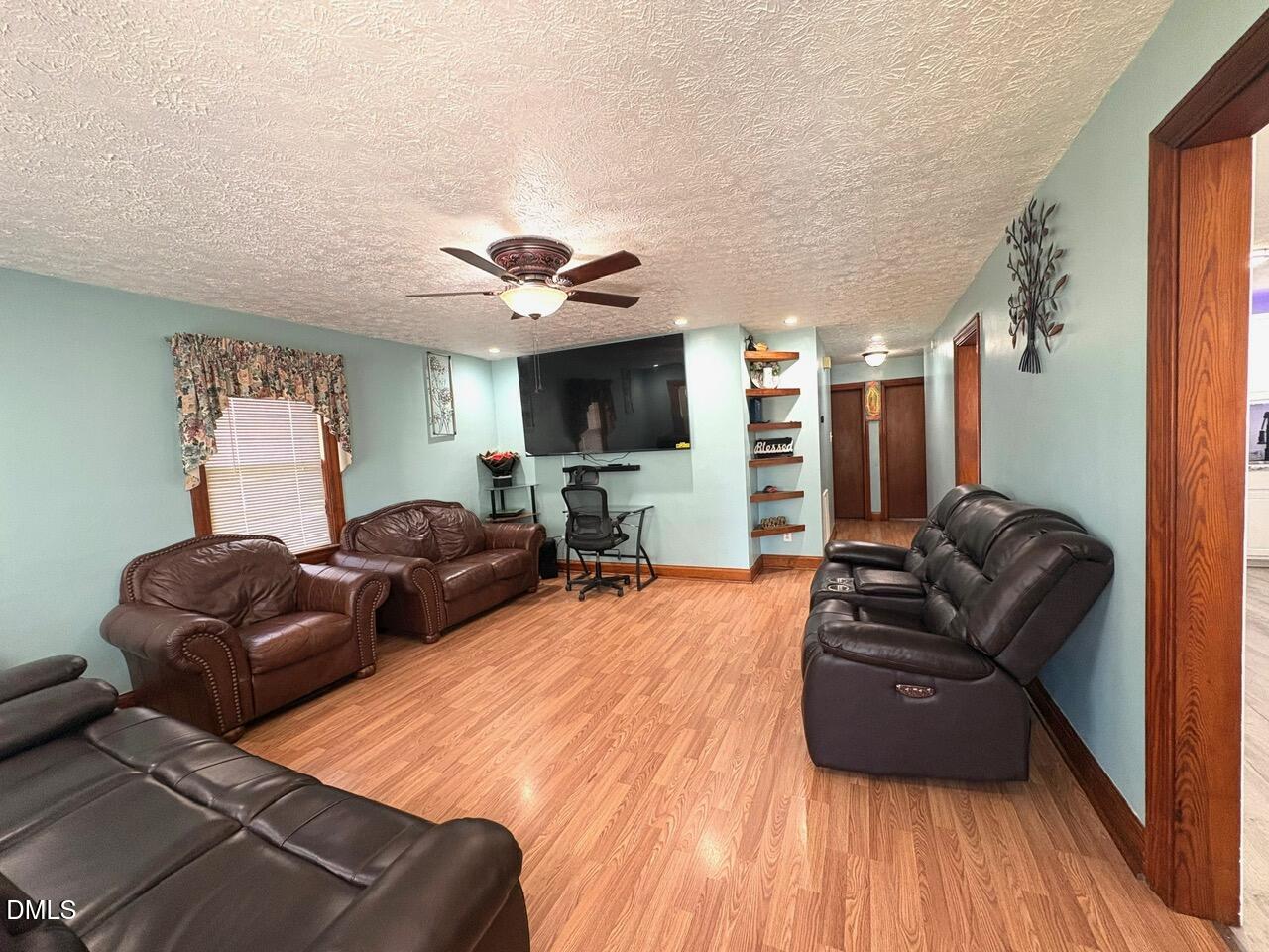 1337 Maple Street Rocky Mount, NC 27803 - Photo 11 of 15 a living room with furniture a flat screen tv and kitchen view