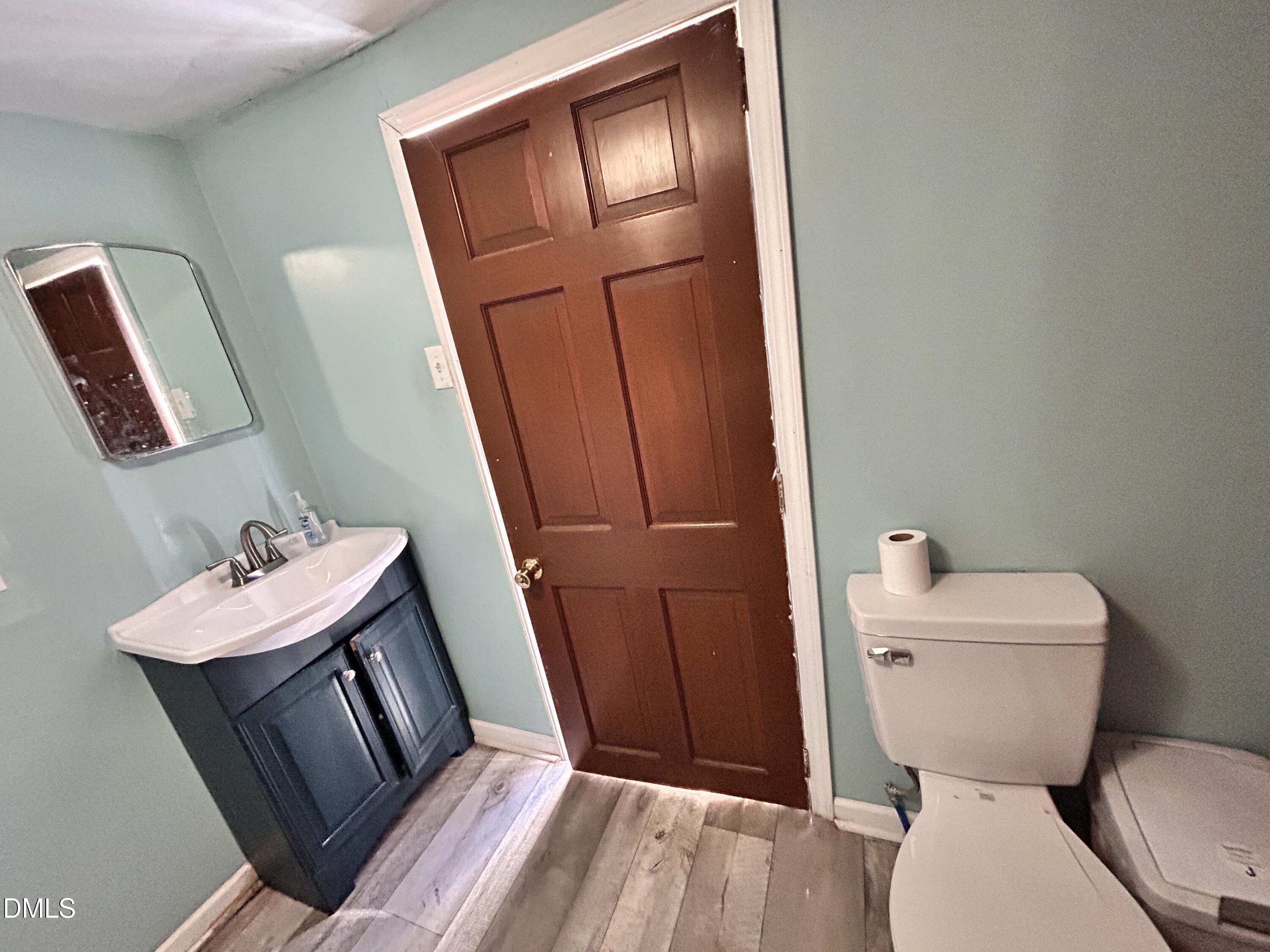 1337 Maple Street Rocky Mount, NC 27803 - Photo 13 of 15 a bathroom with a toilet sink and mirror