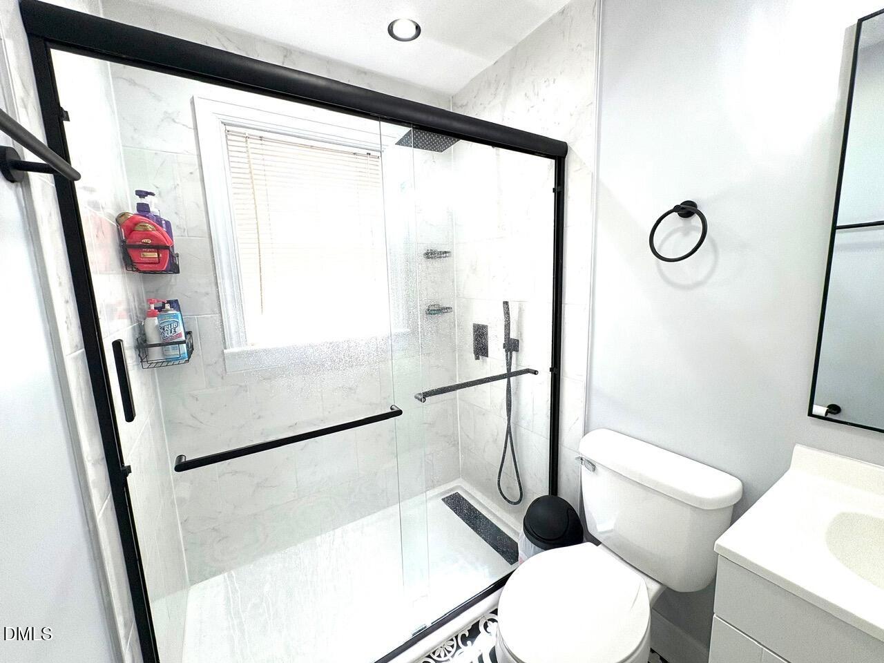 1337 Maple Street Rocky Mount, NC 27803 - Photo 6 of 15 a bathroom with a toilet a sink and a shower