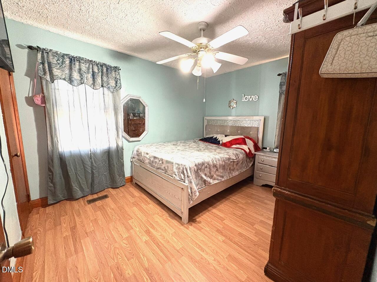 1337 Maple Street Rocky Mount, NC 27803 - Photo 7 of 15 a bedroom with a bed and window