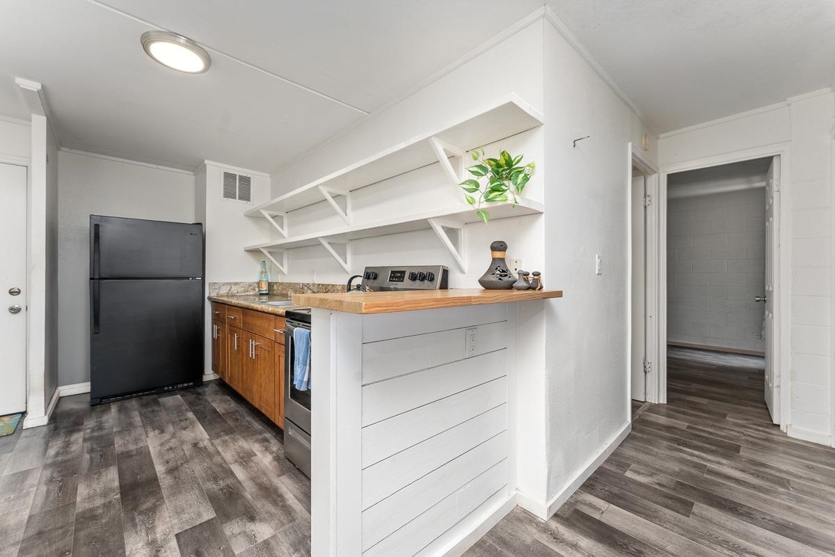111 Kahului Beach Road, Unit A104 Kahului, HI 96732 - Photo 12 of 38 a kitchen with refrigerator cabinets and a window