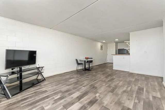 a view of a livingroom with furniture and a flat screen tv