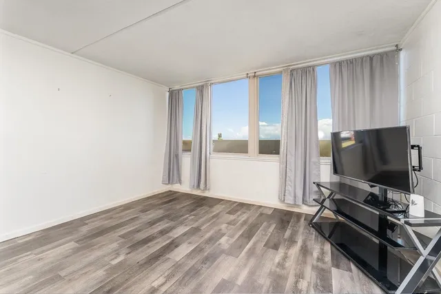 a room with a bed and a flat screen tv