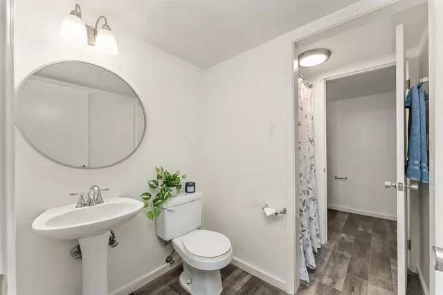 a bathroom with a sink toilet and a mirror