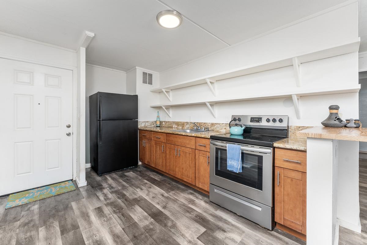 111 Kahului Beach Road, Unit A104 Kahului, HI 96732 - Photo 2 of 38 a kitchen with stainless steel appliances a refrigerator stove and sink