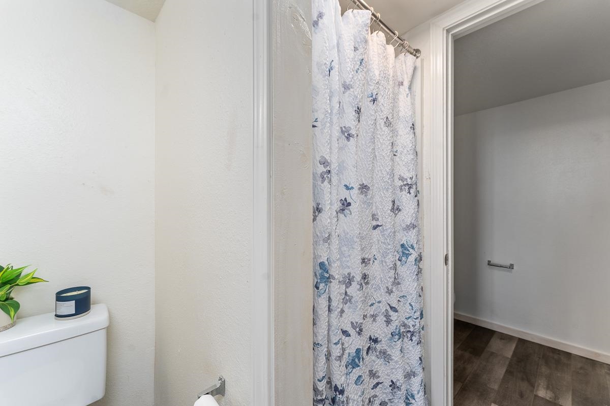 111 Kahului Beach Road, Unit A104 Kahului, HI 96732 - Photo 21 of 38 a bathroom with a shower curtain and a toilet