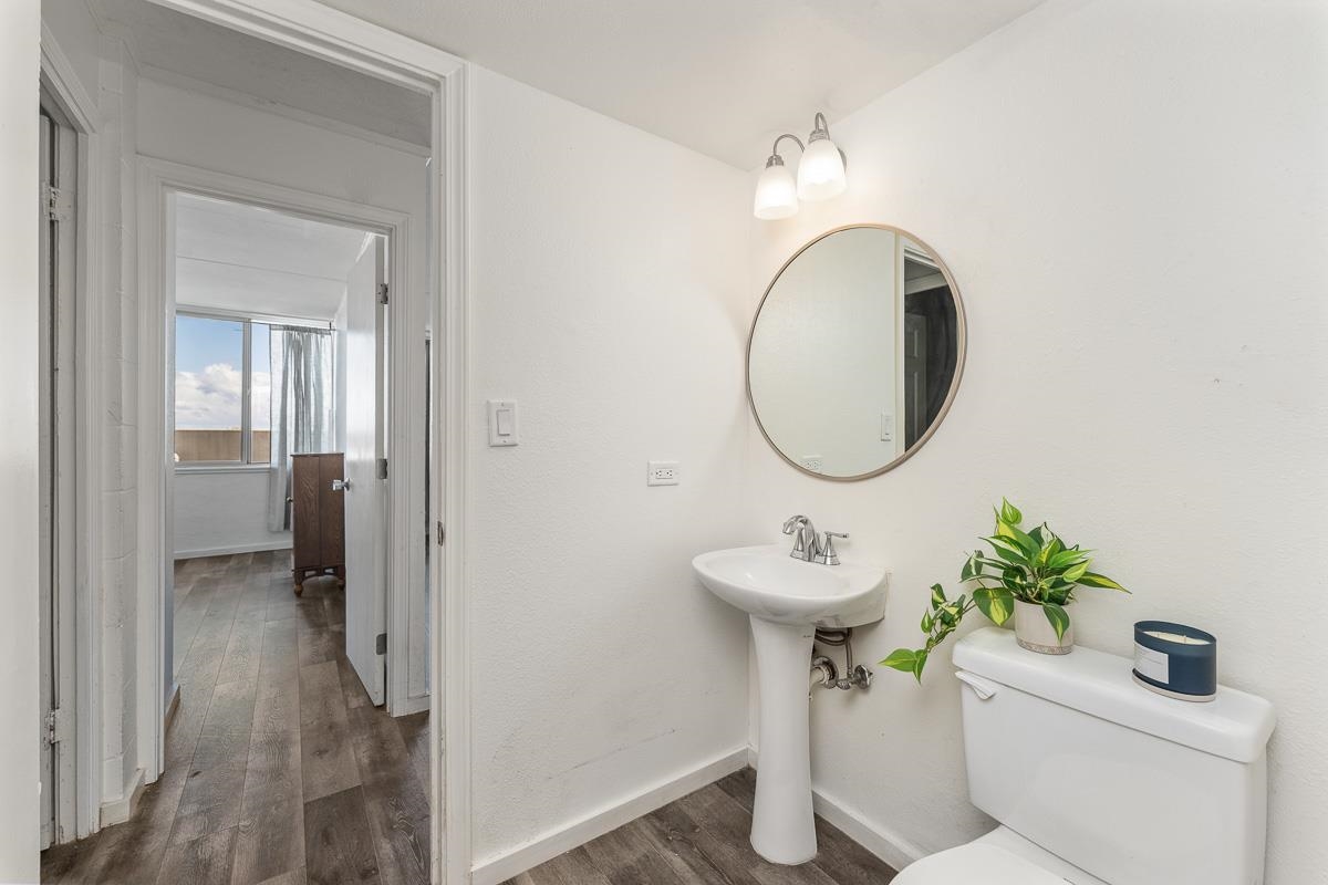 111 Kahului Beach Road, Unit A104 Kahului, HI 96732 - Photo 22 of 38 a bathroom with a sink toilet and a mirror