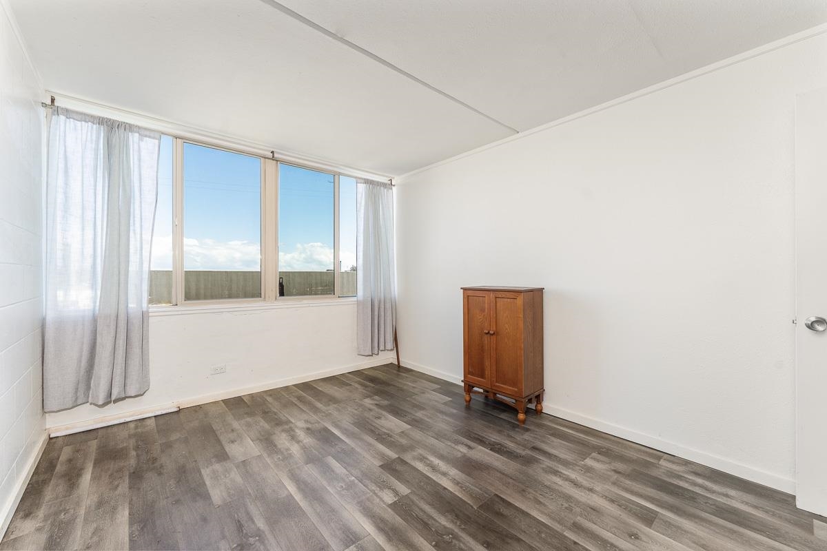 111 Kahului Beach Road, Unit A104 Kahului, HI 96732 - Photo 24 of 38 a view of an empty room with wooden floor and a window