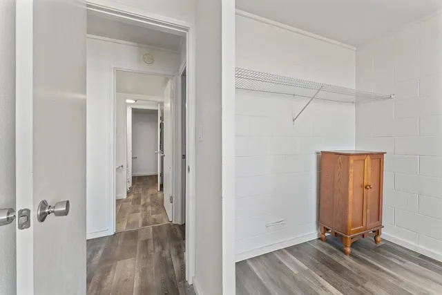 a view of a room with wooden floor and closet area