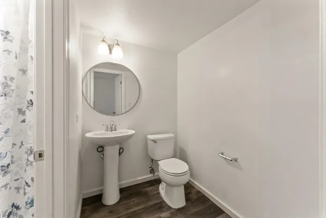 a bathroom with a toilet sink and mirror