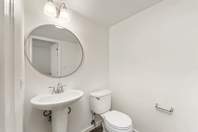 a bathroom with a sink a mirror and toilet