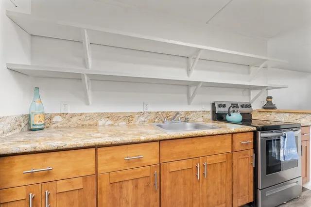 a kitchen with stainless steel appliances granite countertop a sink and cabinets