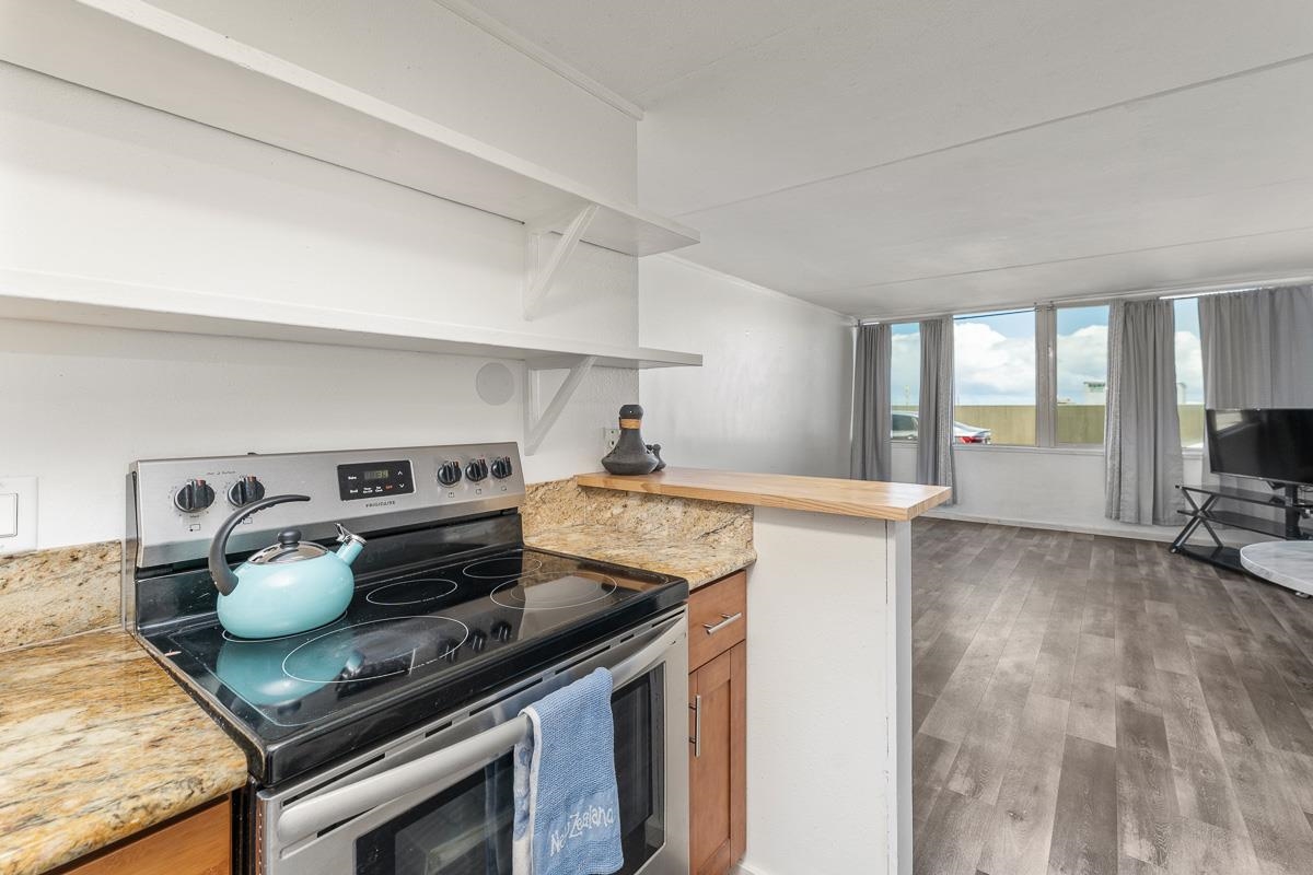 111 Kahului Beach Road, Unit A104 Kahului, HI 96732 - Photo 6 of 38 a kitchen with a stove and a refrigerator