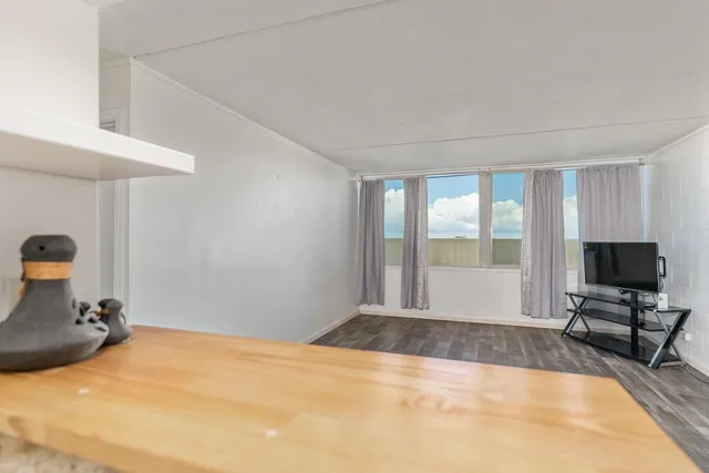 a view of a livingroom with workspace and a tub