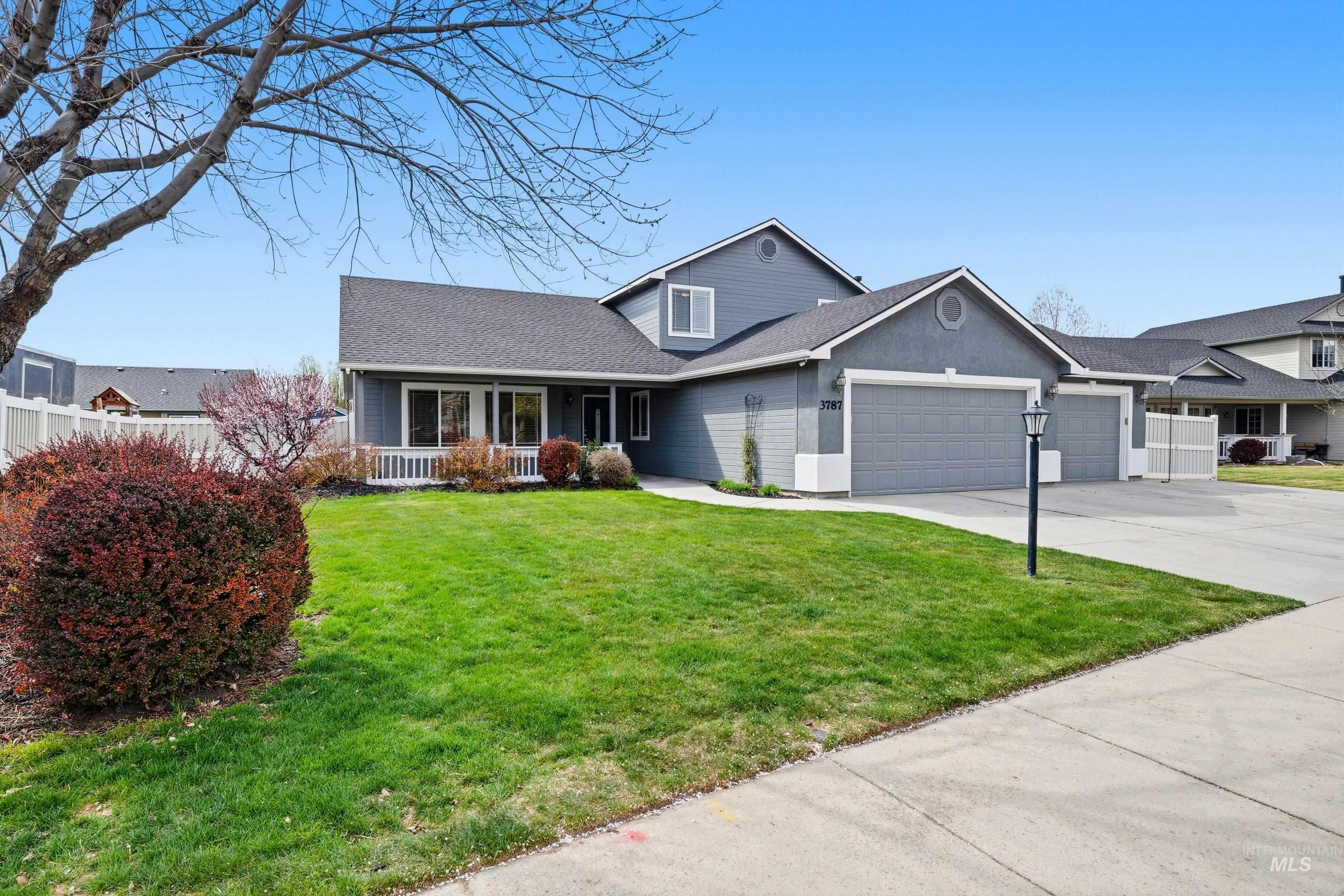 3787 North Alexis Way Meridian, ID 83646 - Photo 2 of 50 Traditional home with a garage, driveway, covered porch, a shingled roof, and stucco siding