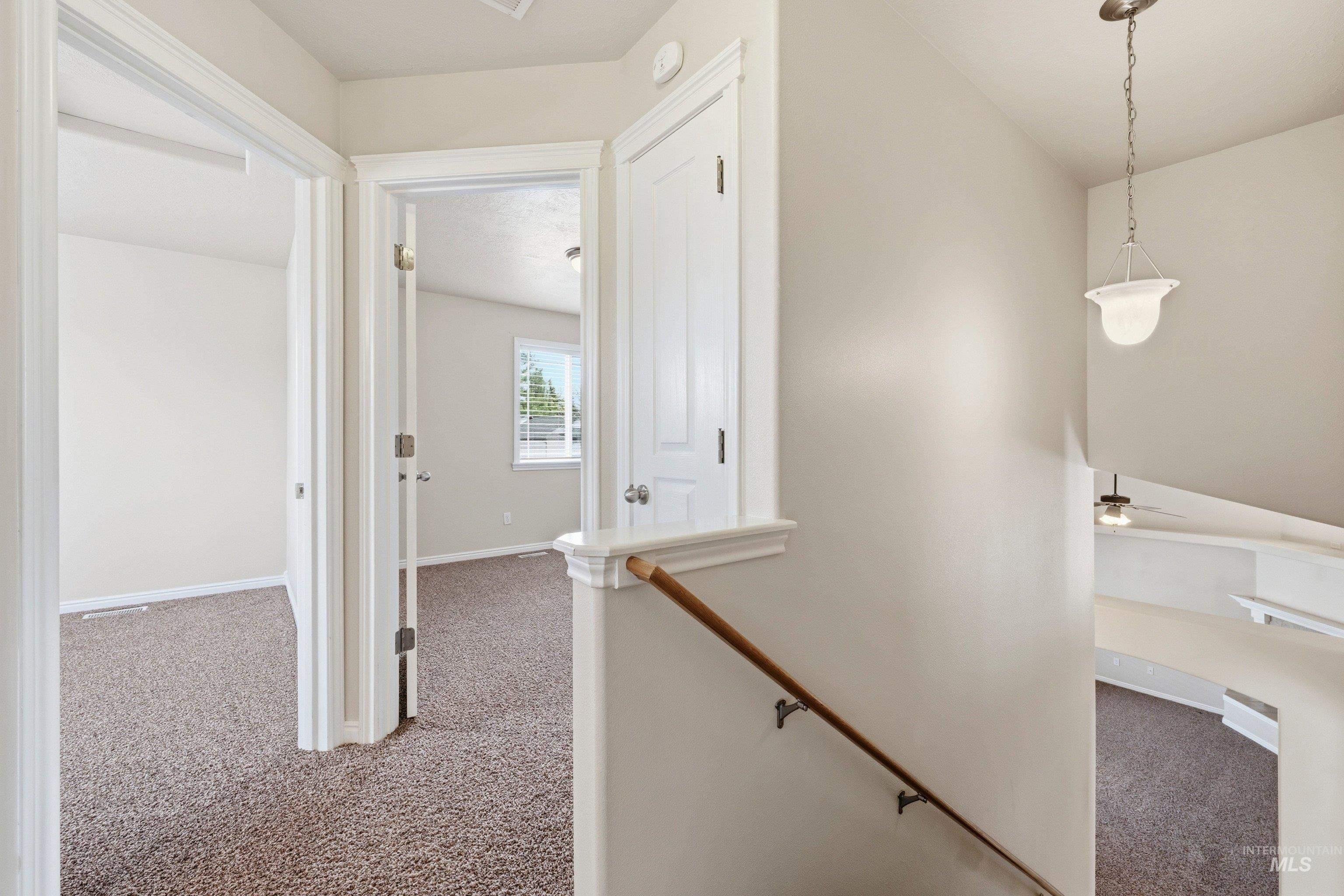 3787 North Alexis Way Meridian, ID 83646 - Photo 28 of 50 Hallway featuring light colored carpet and an upstairs landing