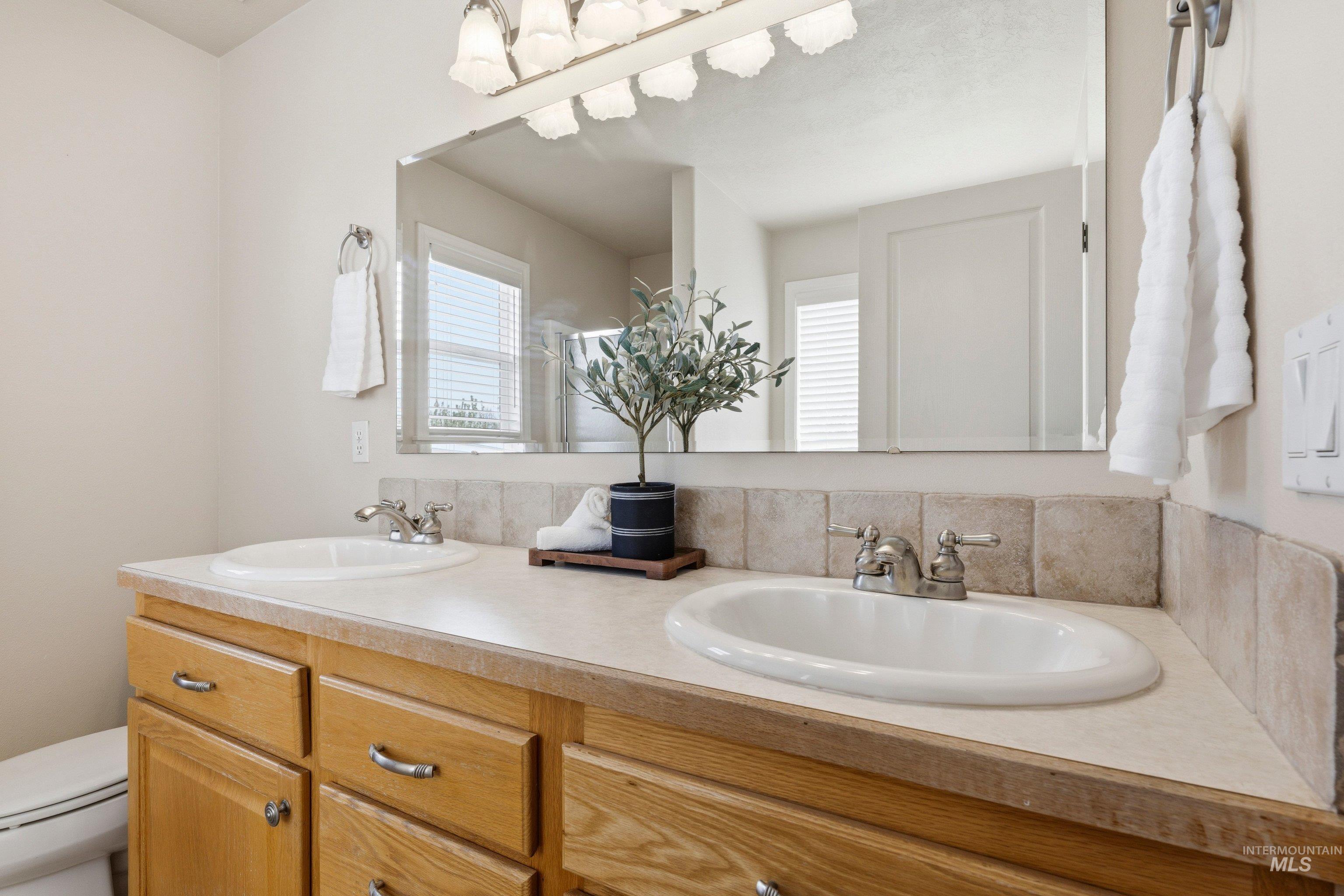 3787 North Alexis Way Meridian, ID 83646 - Photo 31 of 50 Bathroom featuring double vanity and a shower stall