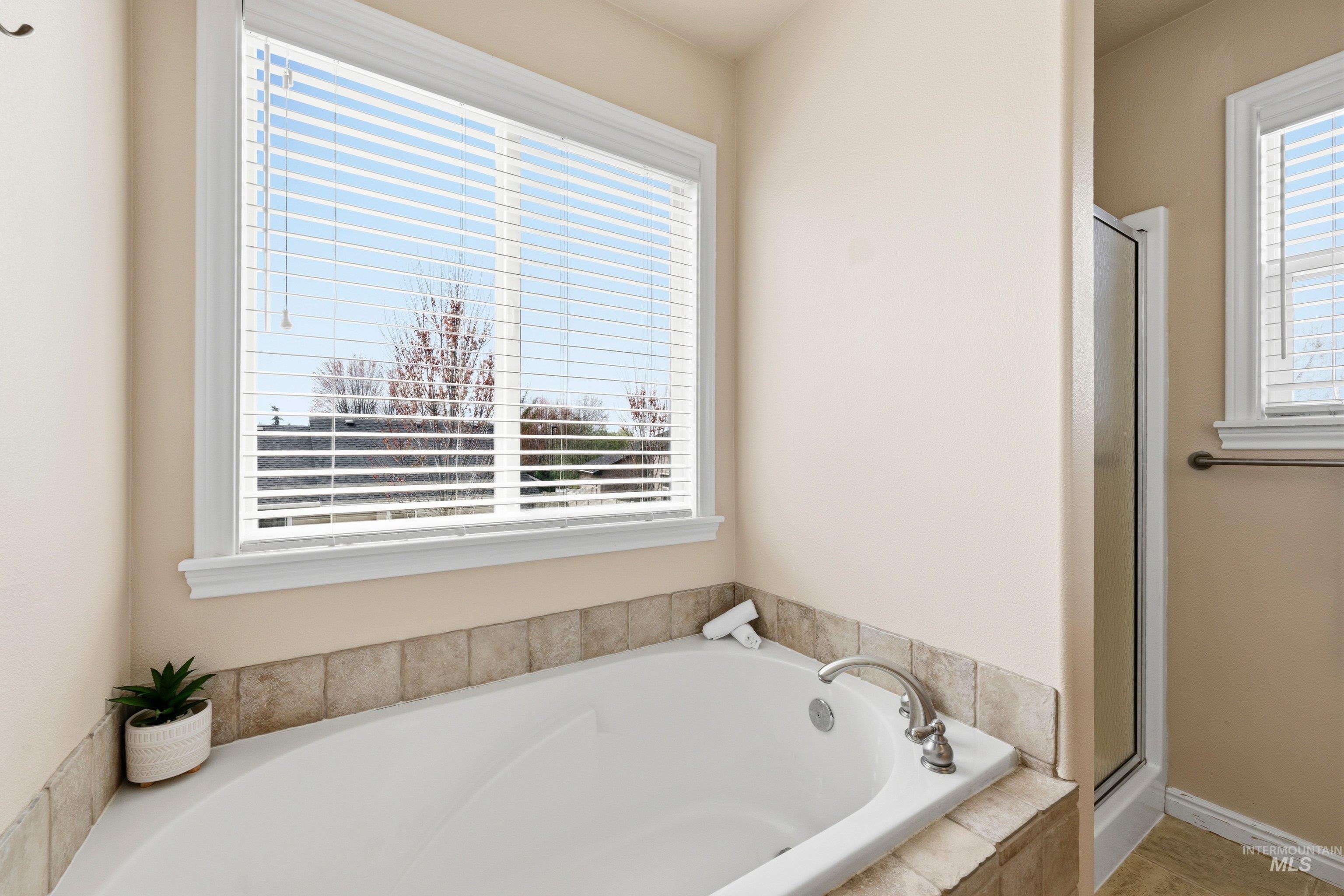 3787 North Alexis Way Meridian, ID 83646 - Photo 32 of 50 Full bathroom with a stall shower and a garden tub