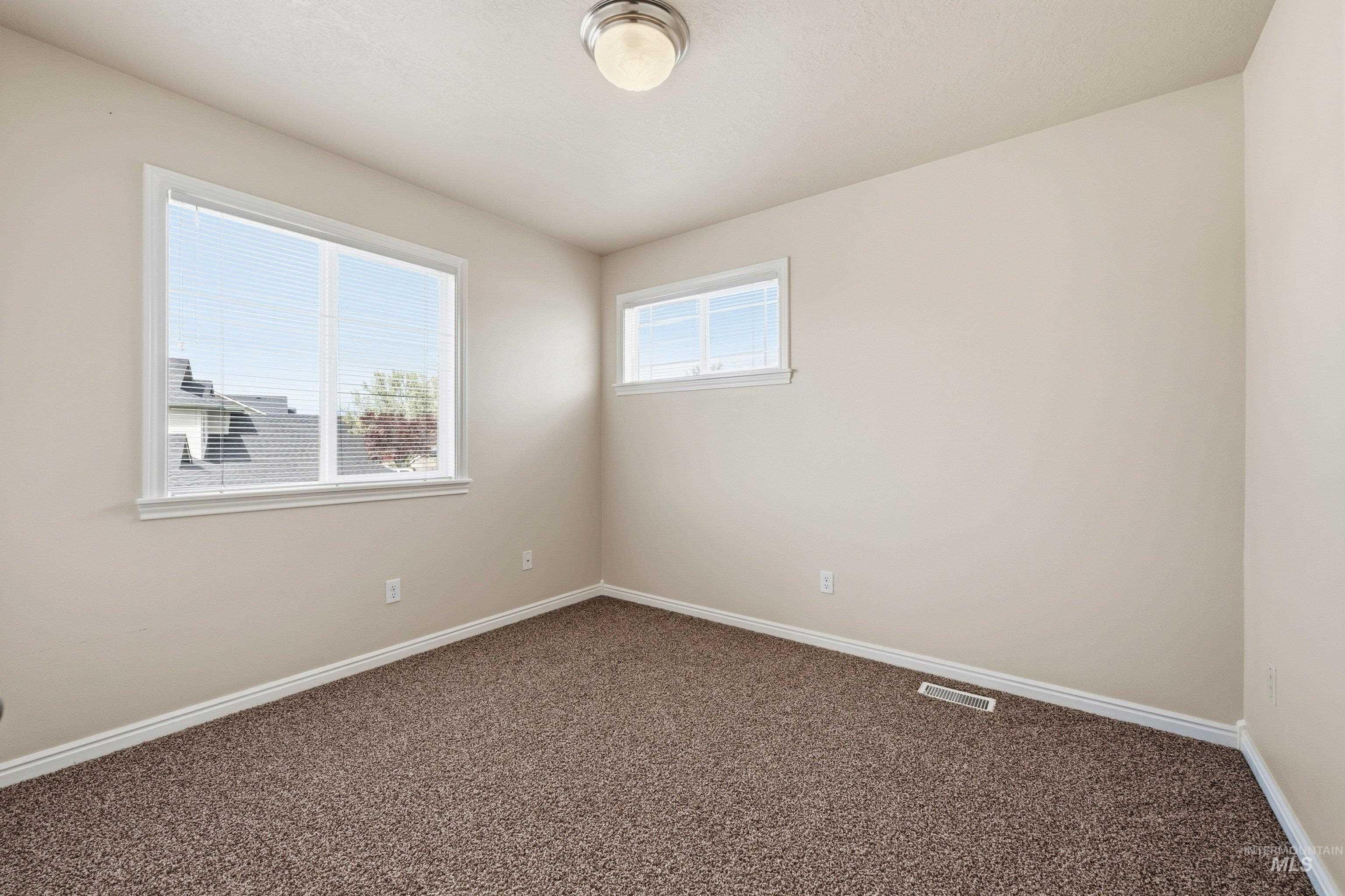 3787 North Alexis Way Meridian, ID 83646 - Photo 35 of 50 Spare room featuring baseboards and dark carpet