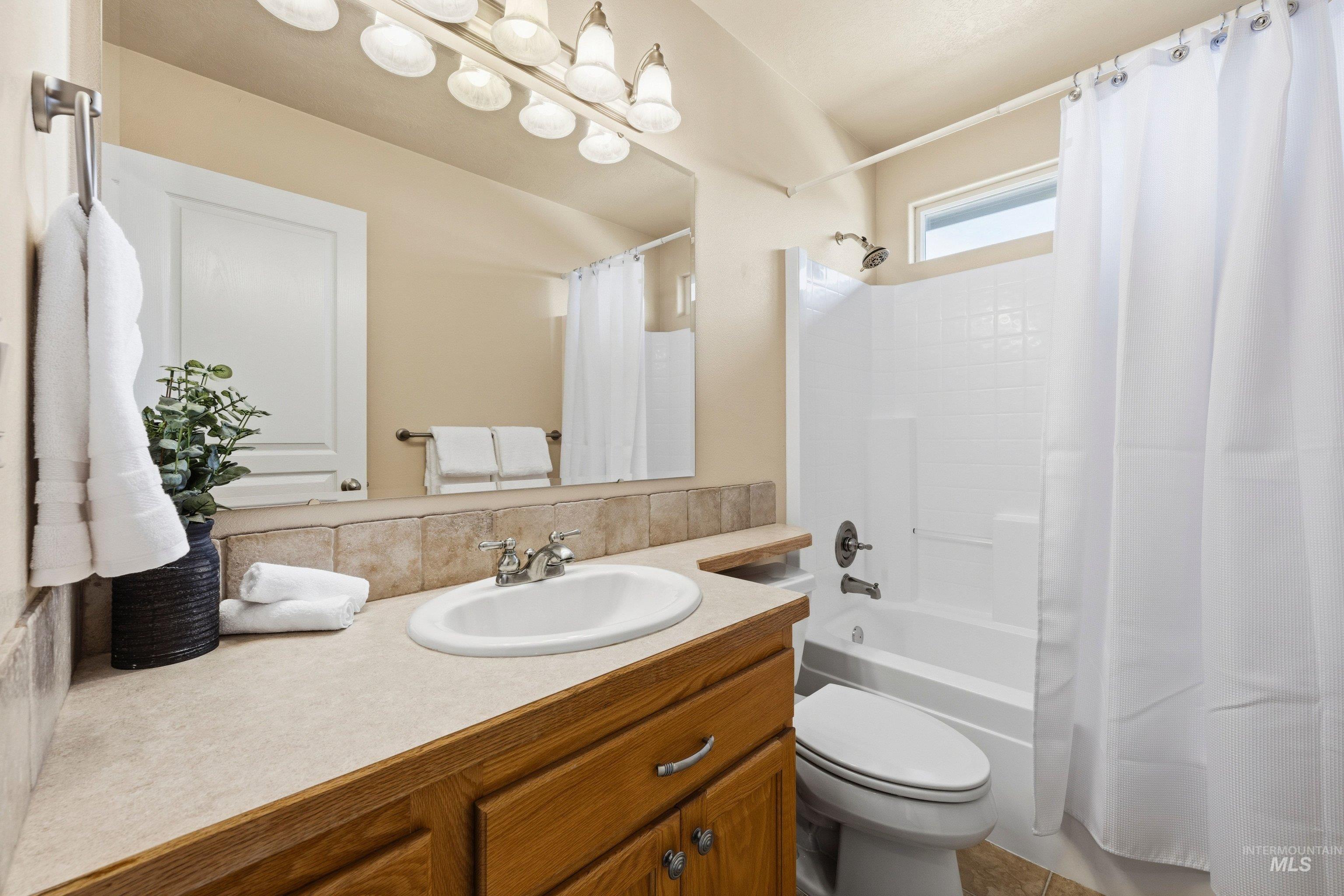 3787 North Alexis Way Meridian, ID 83646 - Photo 36 of 50 Full bathroom featuring vanity and shower / bath combo with shower curtain