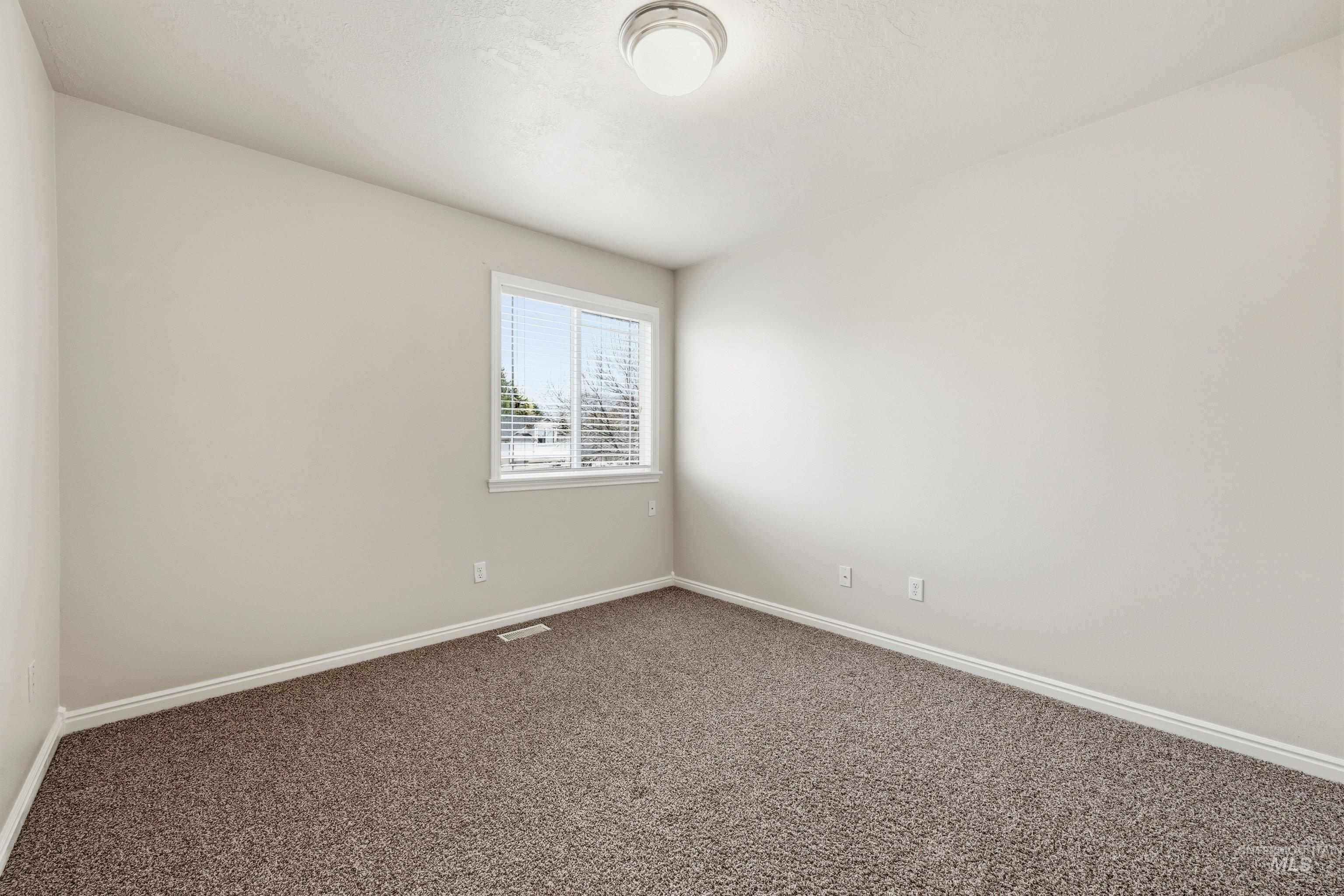 3787 North Alexis Way Meridian, ID 83646 - Photo 37 of 50 Spare room with baseboards and dark colored carpet