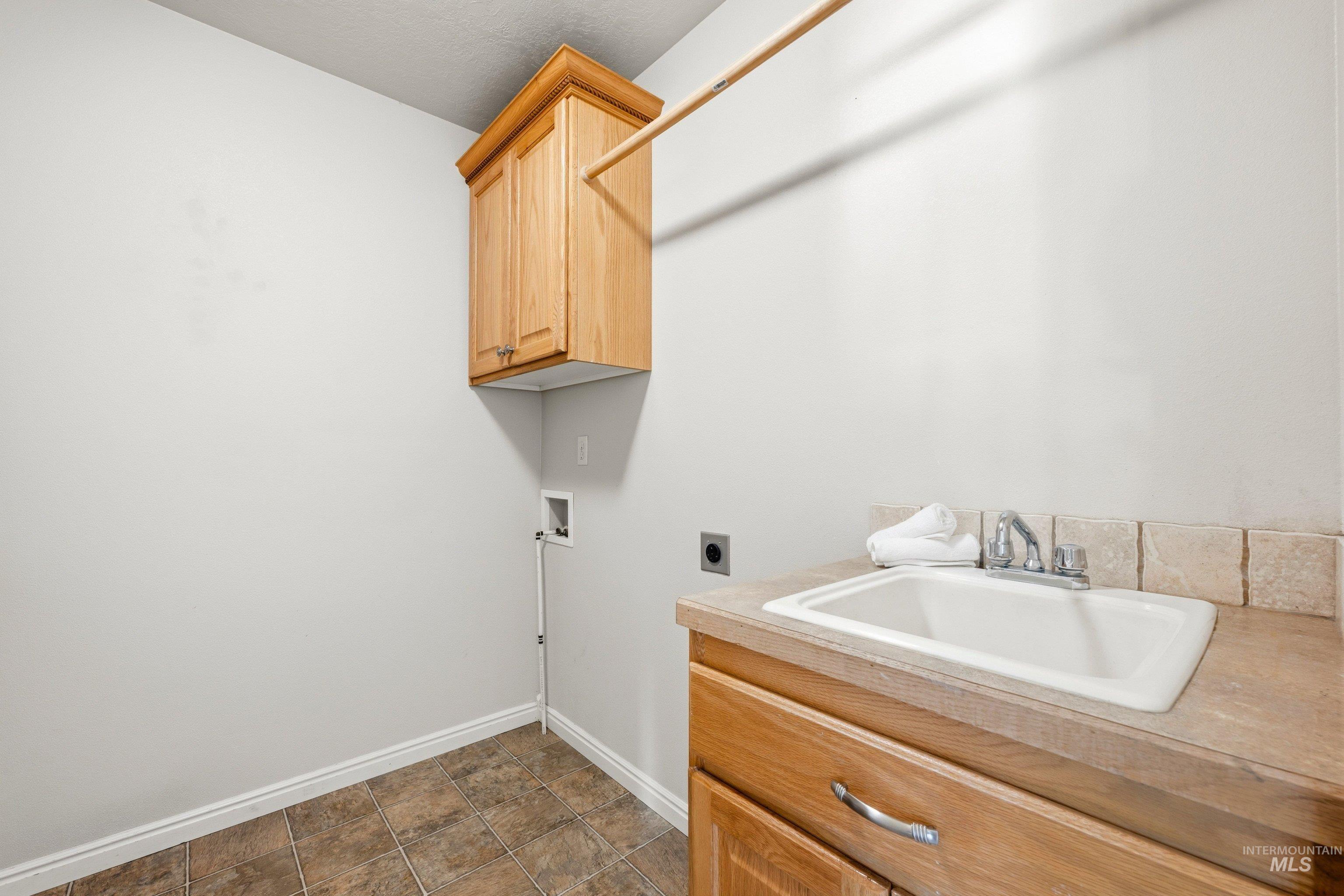 3787 North Alexis Way Meridian, ID 83646 - Photo 39 of 50 Laundry room featuring hookup for a washing machine, cabinet space, electric dryer hookup, and stone finish floors