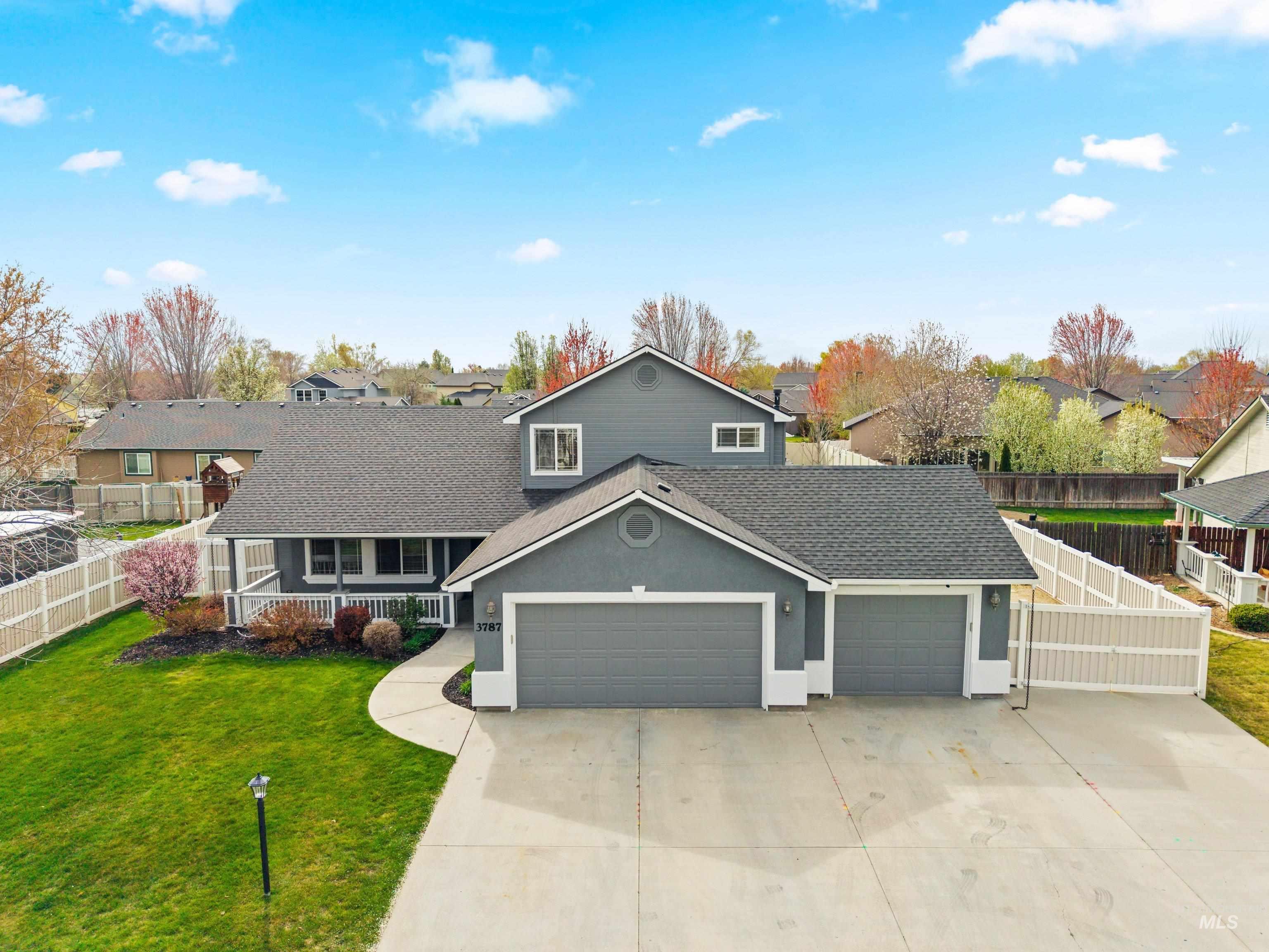 3787 North Alexis Way Meridian, ID 83646 - Photo 44 of 50 View of front of house with a garage, driveway, a shingled roof, stucco siding, and a residential view