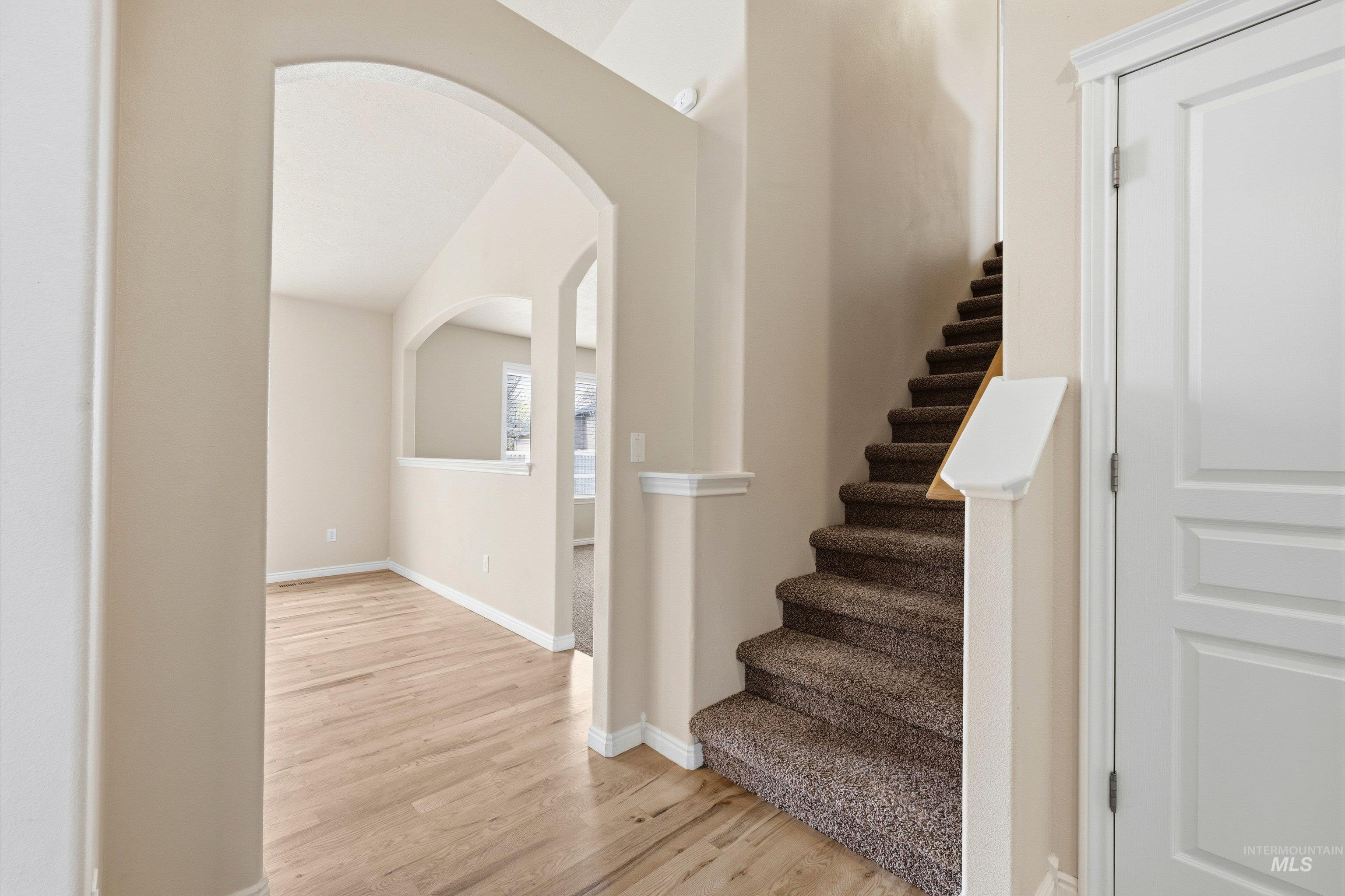 3787 North Alexis Way Meridian, ID 83646 - Photo 7 of 50 Stairway with wood finished floors and arched walkways