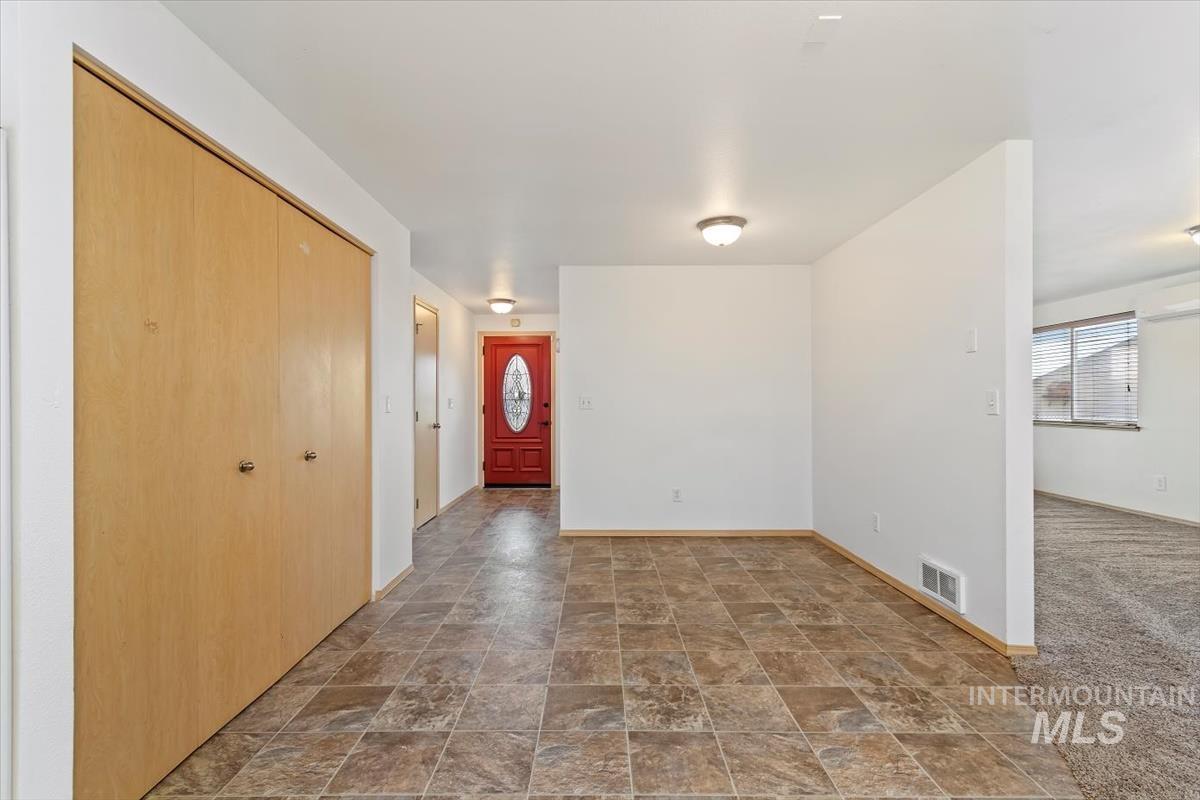 1051 Haas Road Weiser, ID 83672 - Photo 17 of 44 Foyer featuring stone finish floors and dark carpet