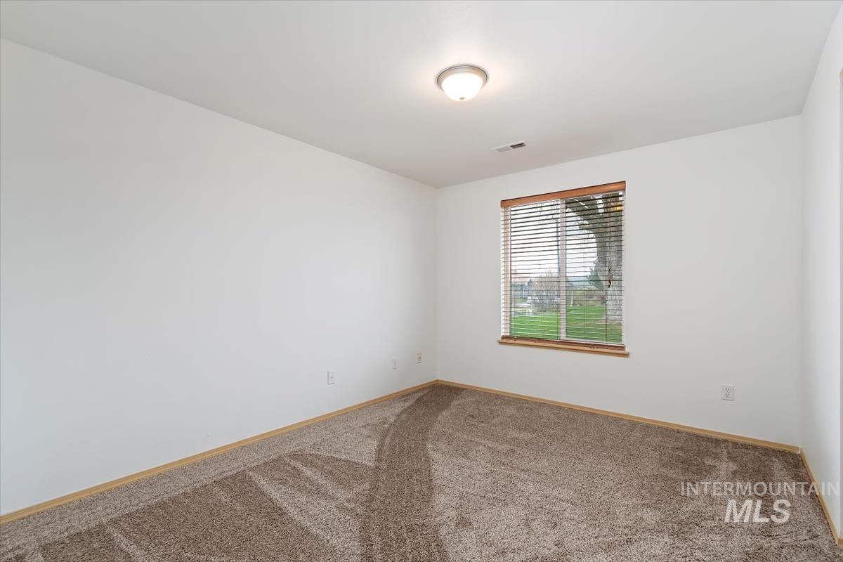 1051 Haas Road Weiser, ID 83672 - Photo 21 of 44 Empty room with carpet floors and baseboards