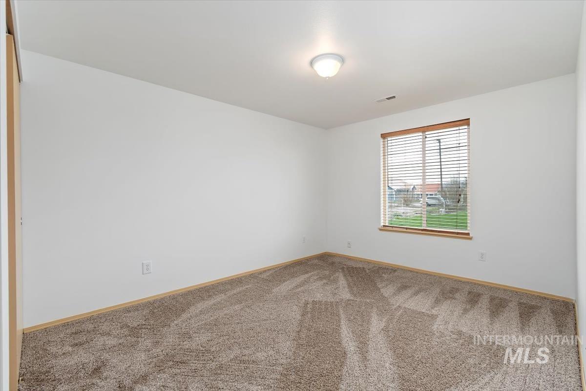 1051 Haas Road Weiser, ID 83672 - Photo 22 of 44 Unfurnished room featuring light carpet and baseboards