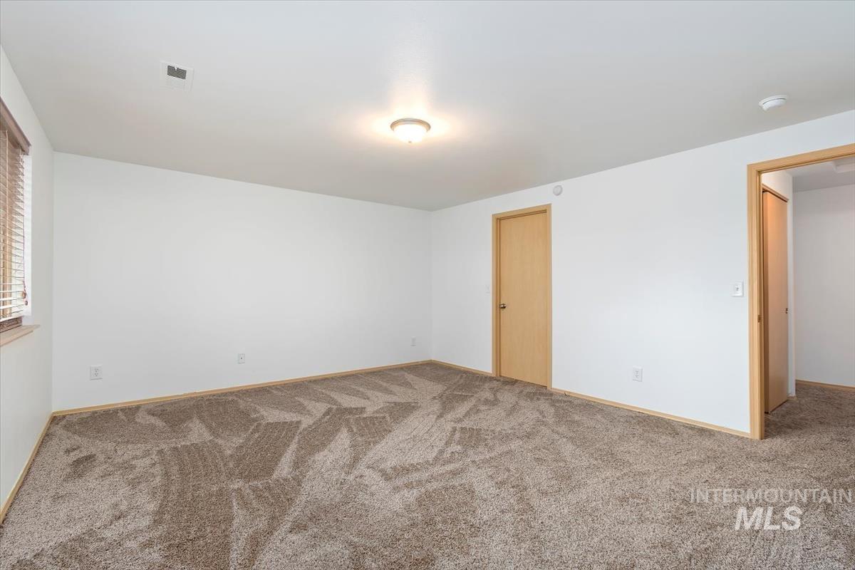 1051 Haas Road Weiser, ID 83672 - Photo 24 of 44 Spare room featuring light carpet and baseboards