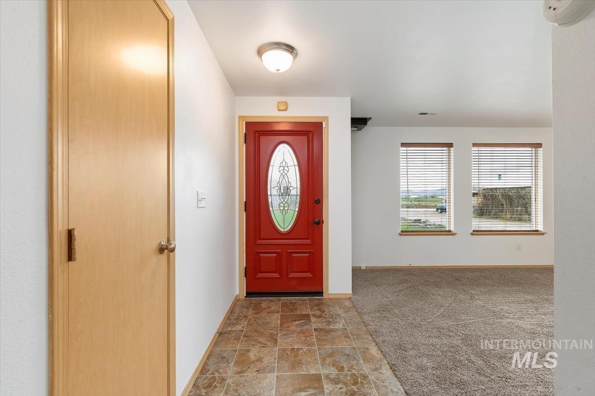 1051 Haas Road Weiser, ID 83672 - Photo 3 of 44 Foyer entrance featuring stone finish flooring and light colored carpet